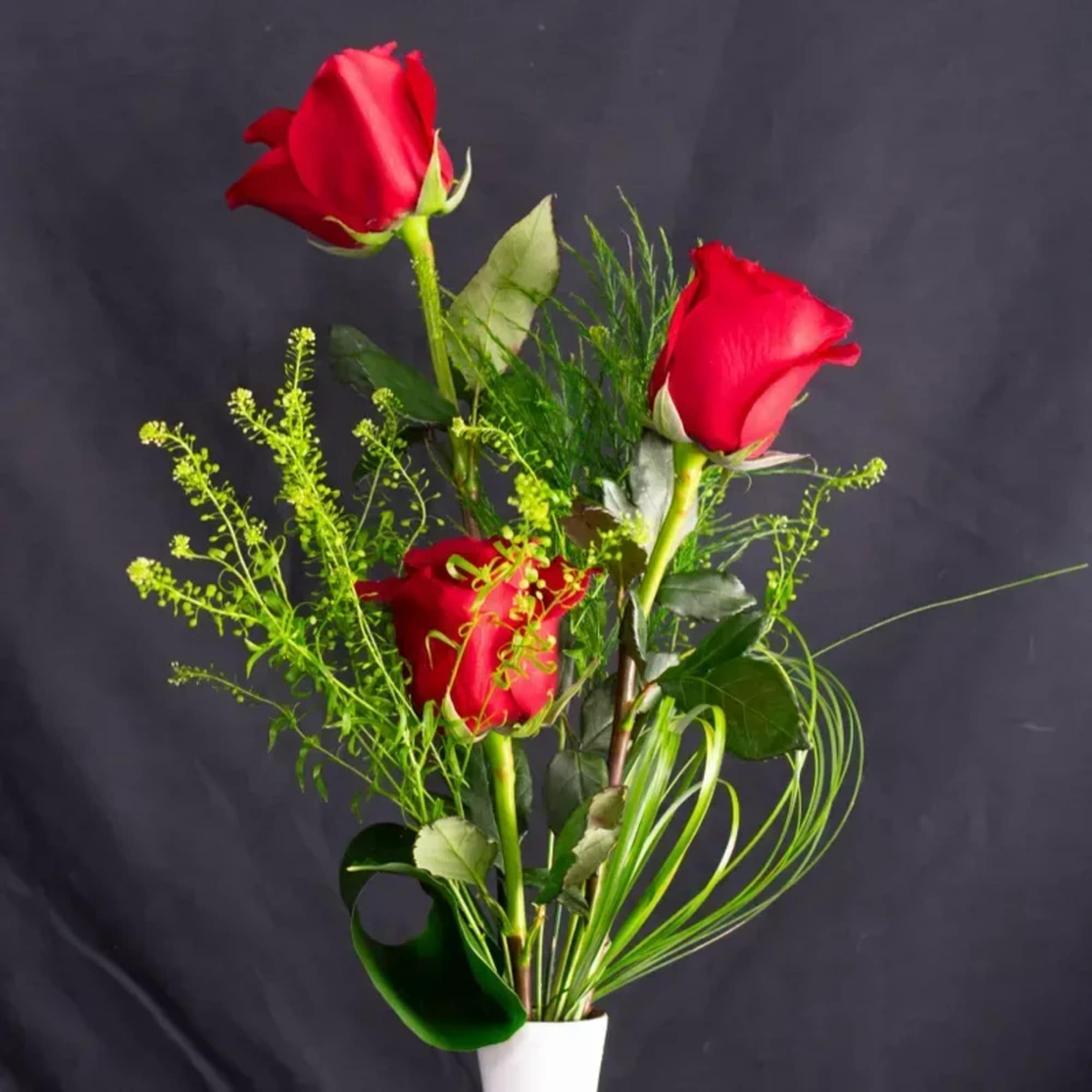 Simple, sweet, and timeless, Just Because features three classic red roses arranged