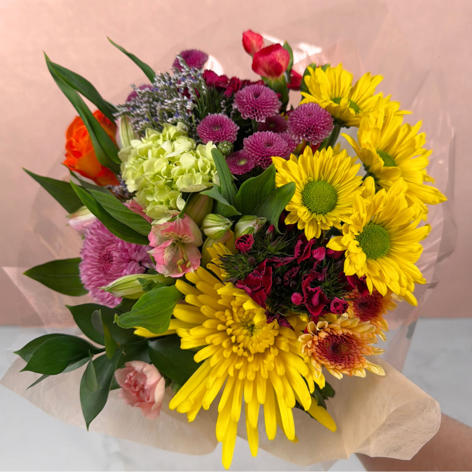 Our Bright &amp; Cheerful Wrapped Bouquet features a bright blend of vibrant