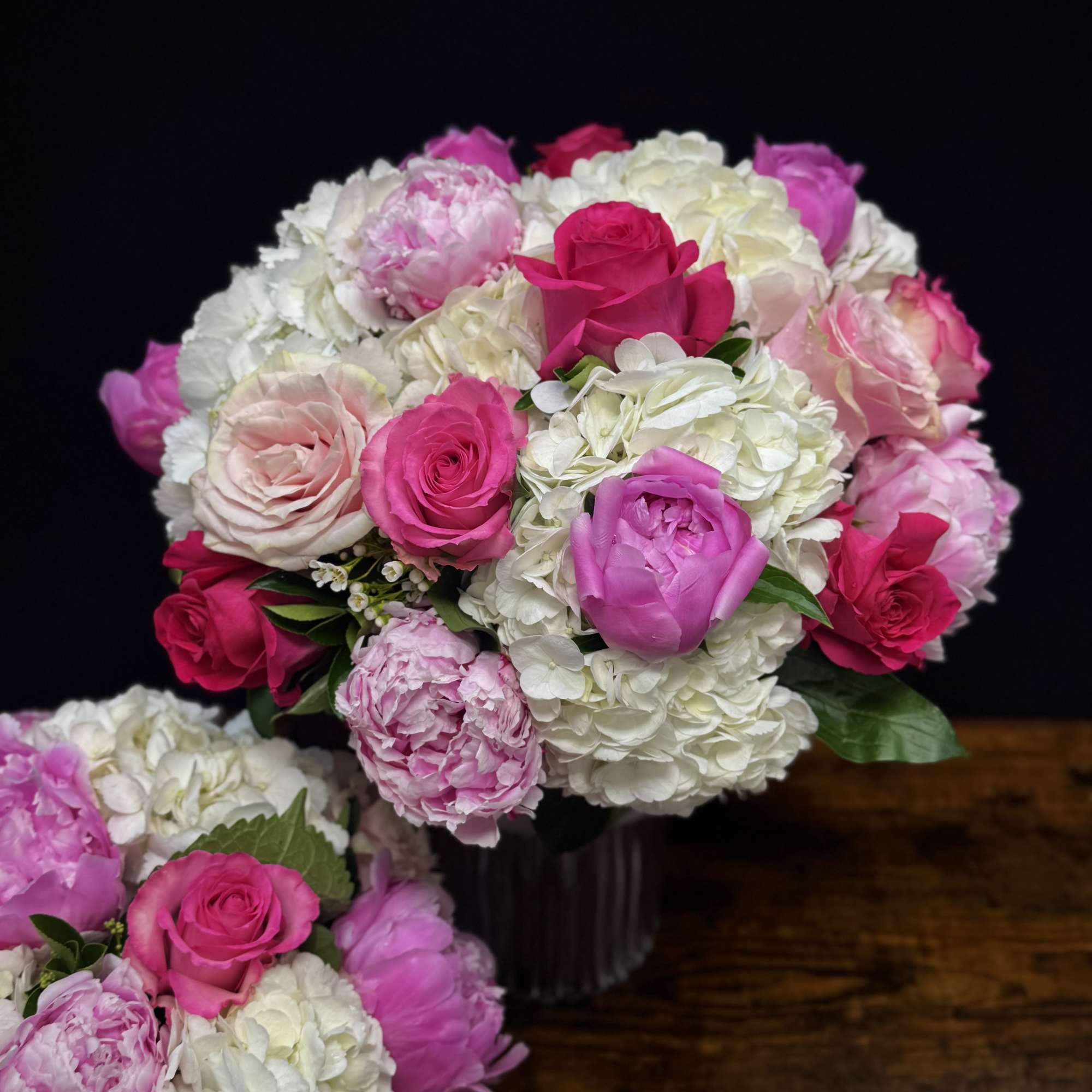 A Beautiful arrangemnt of 2 different shades of peonies, 3 different shaeds