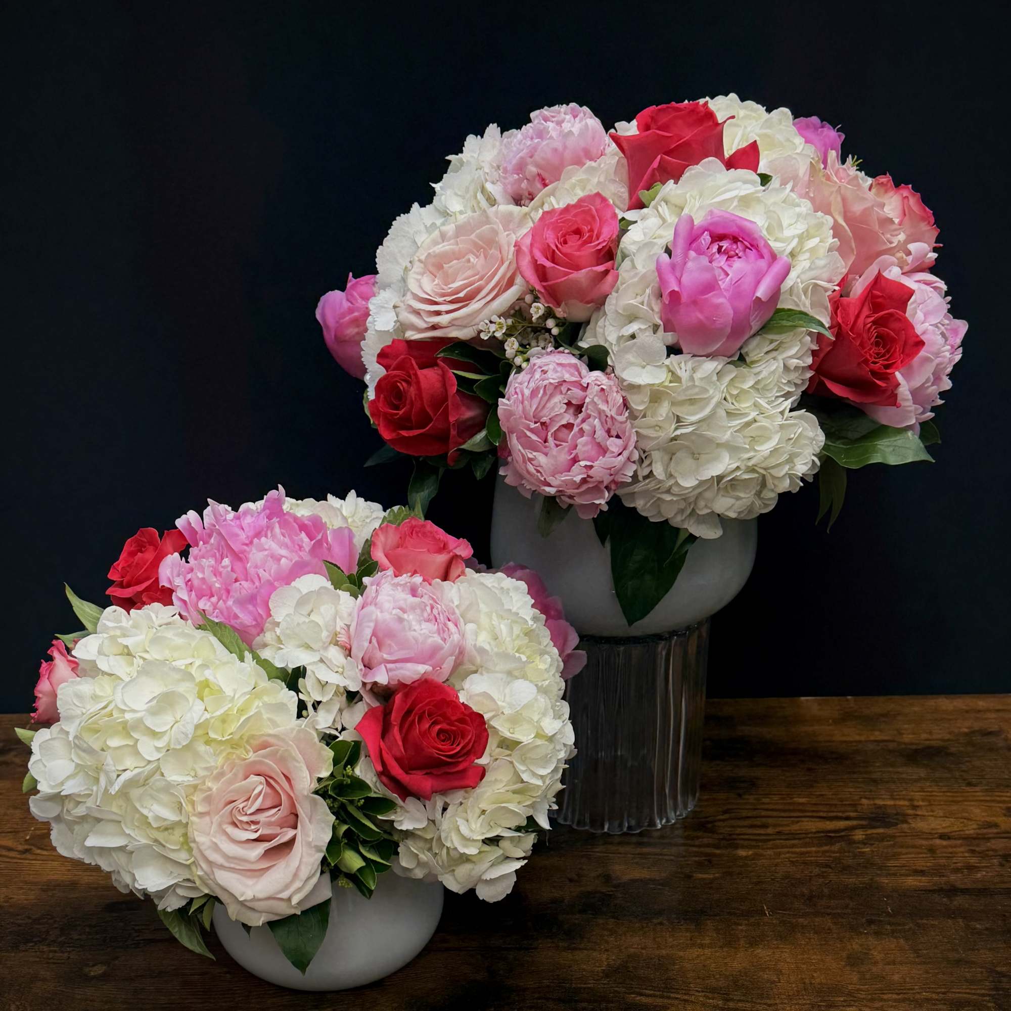 A Beautiful arrangemnt of 2 different shades of peonies, 3 different shaeds