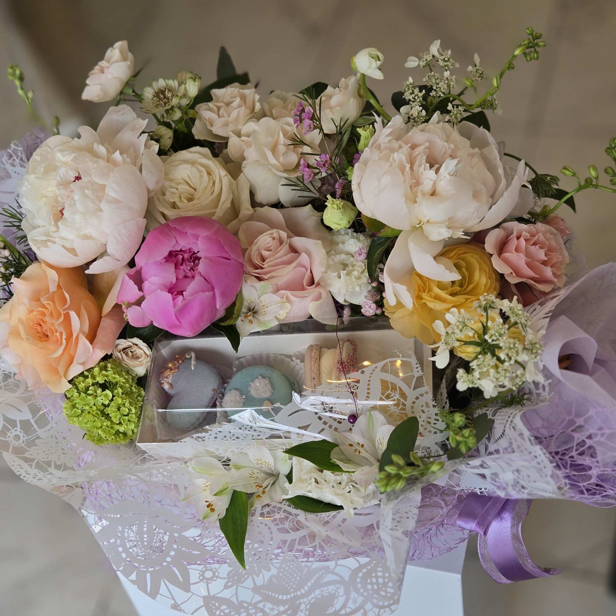 A special Mother&rsquo;s Day flower basket paired with delicate macarons, creating a