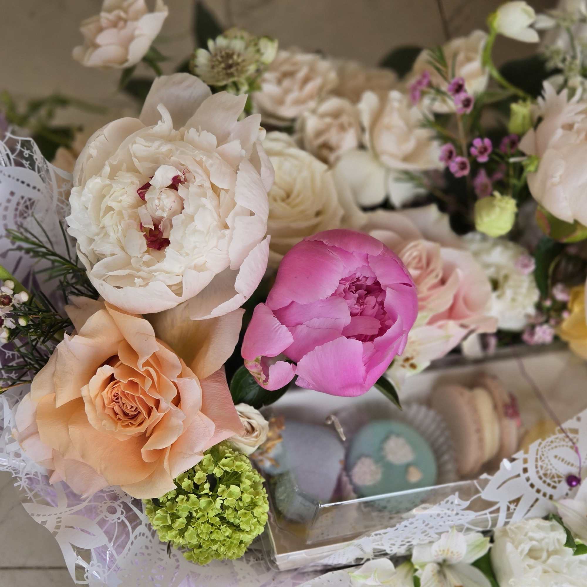 A special Mother&rsquo;s Day flower basket paired with delicate macarons, creating a