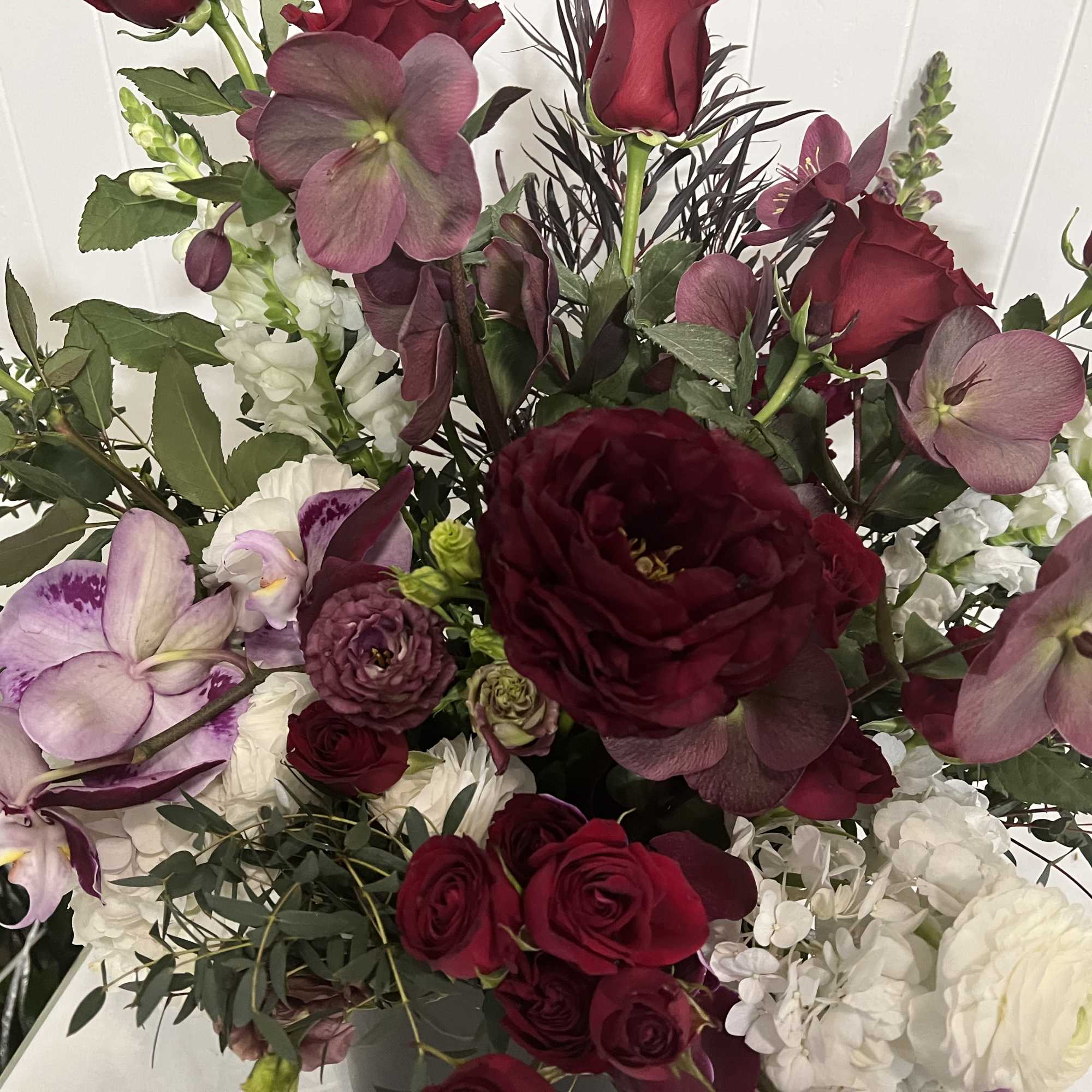Bouquet of burgundy and lavender flowers with white blooms