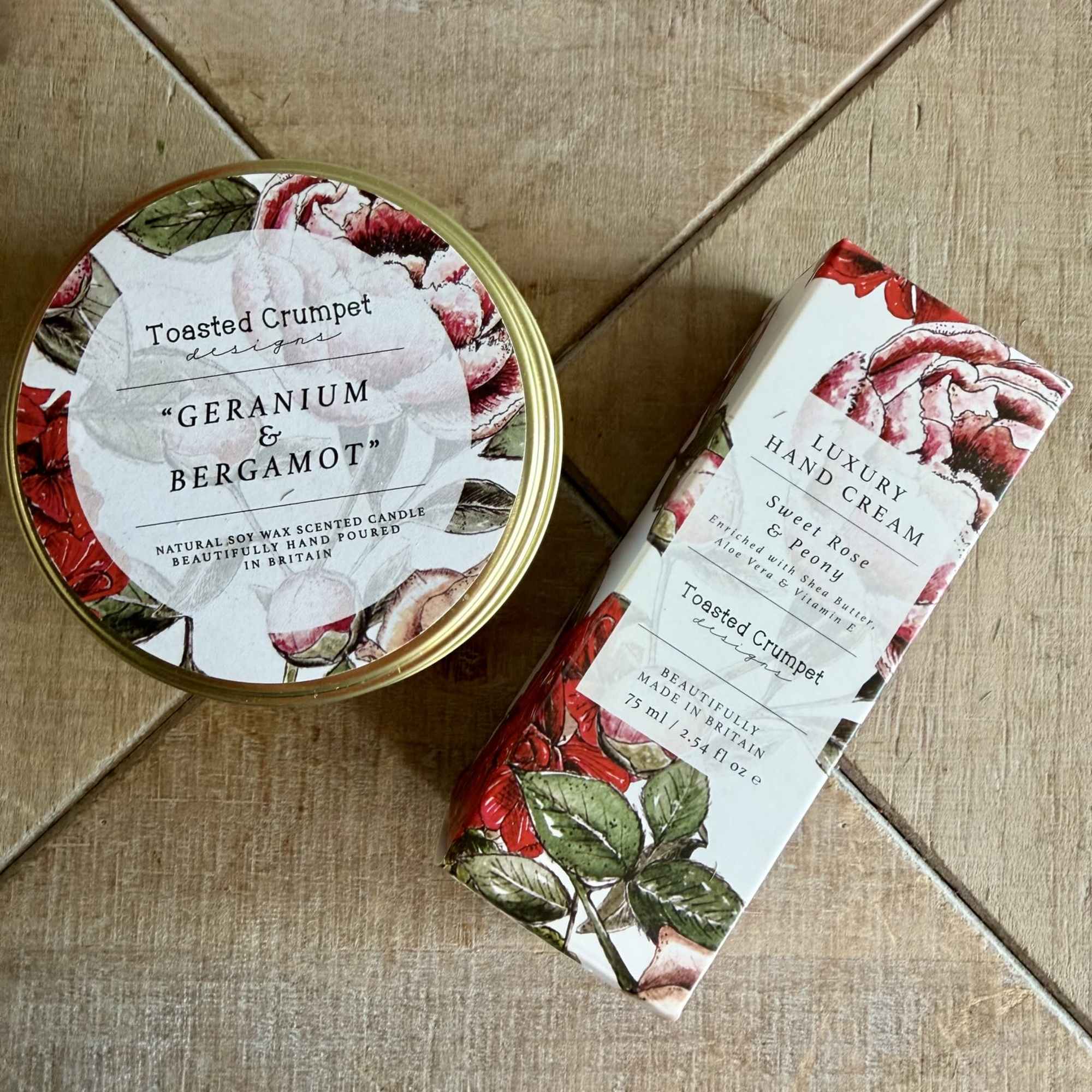 A bright red silk potted geranium anchors this cheerful plant-and-gift bundle, perfect