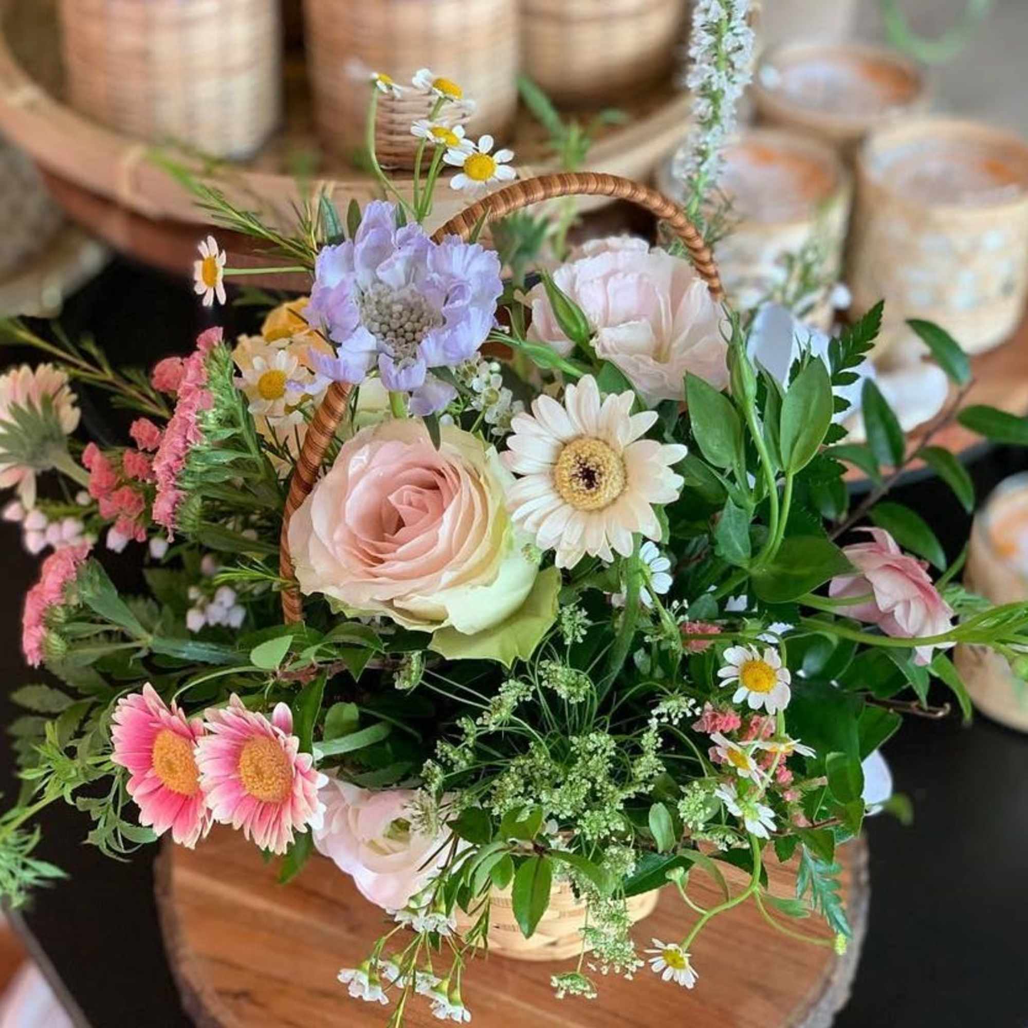 Seasonal pastel flowers in a woven basket. Perfect for gifting.