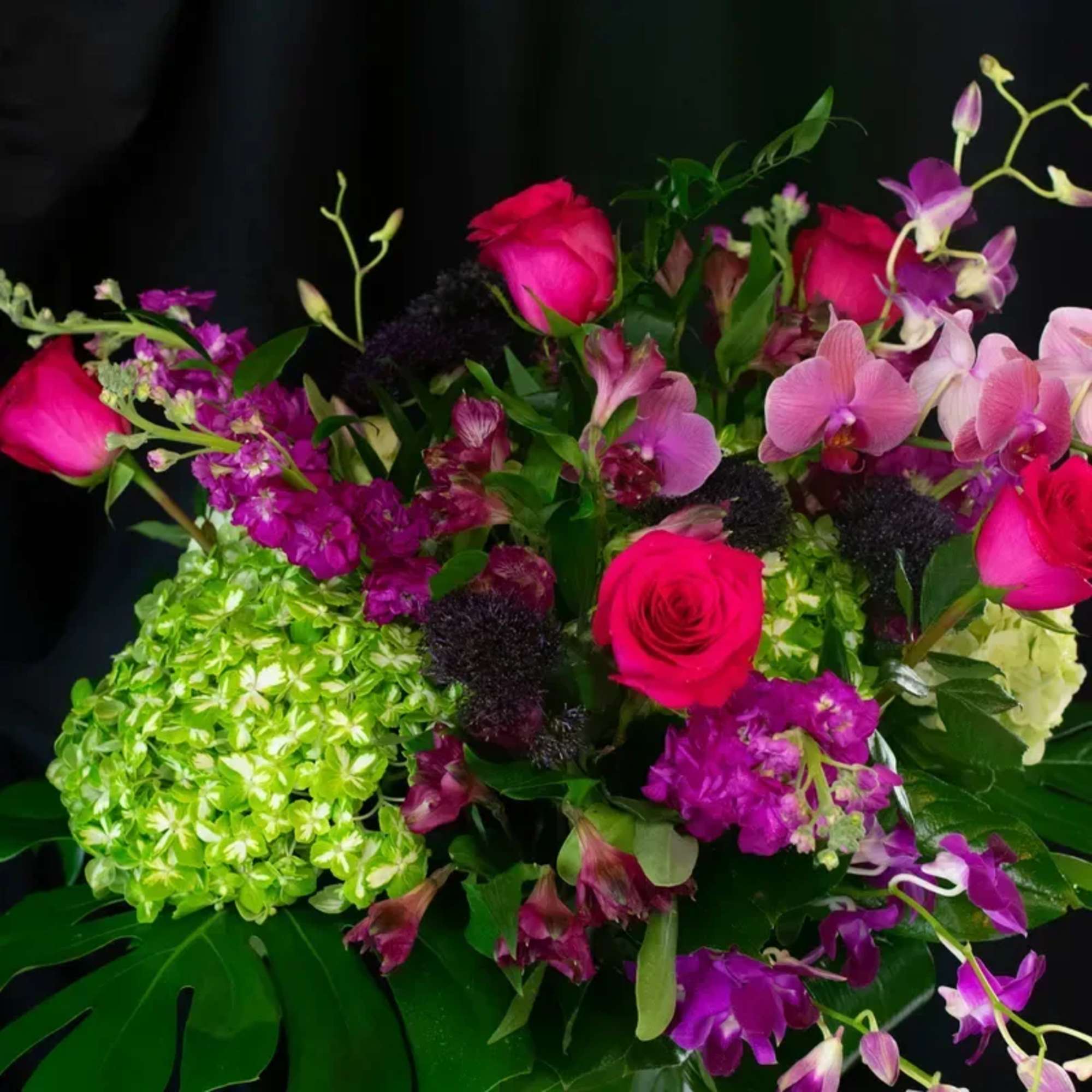 This elegant arrangement in a gorgeous glass vase is such a show