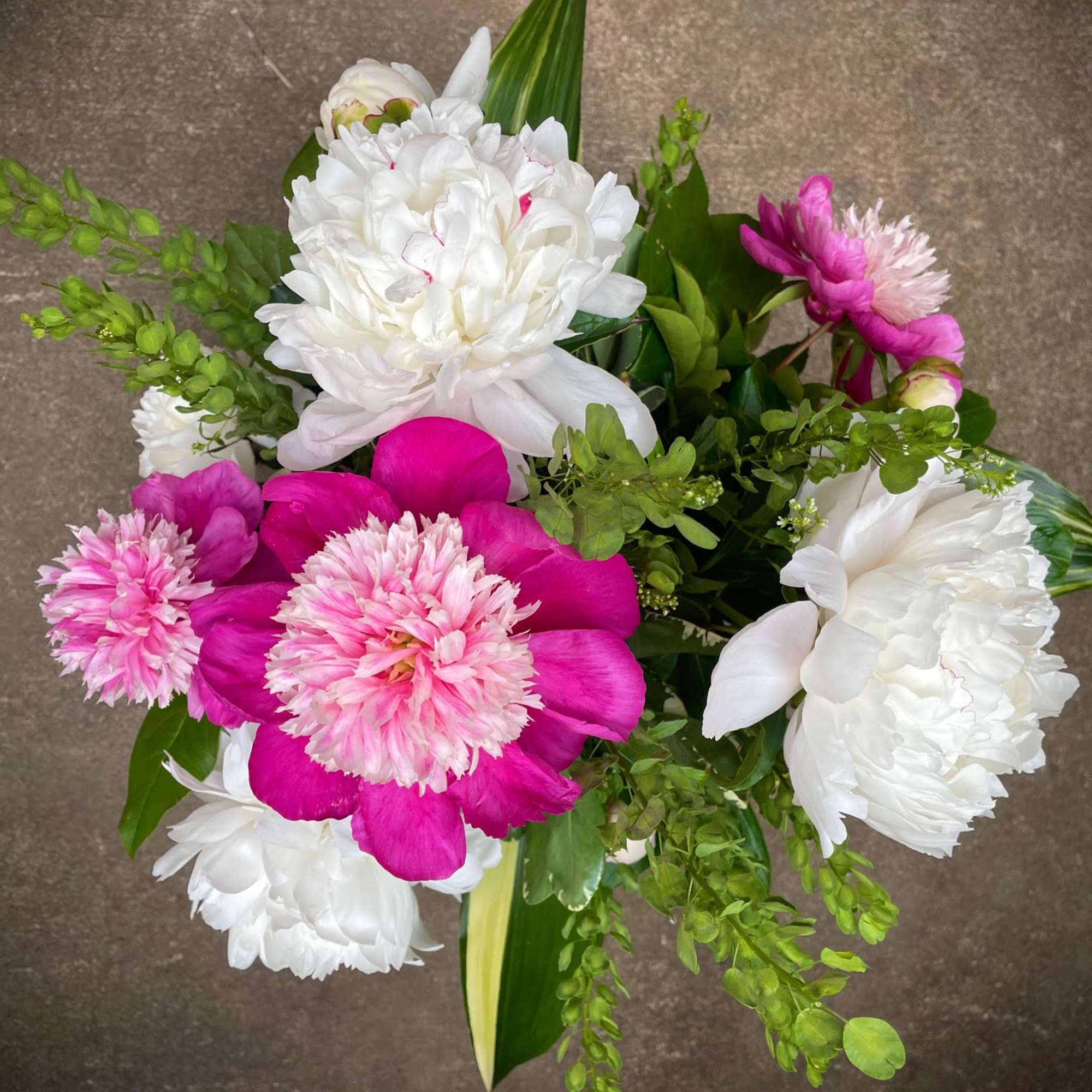 Pink and white mixed bouquet with large blooms and greenery