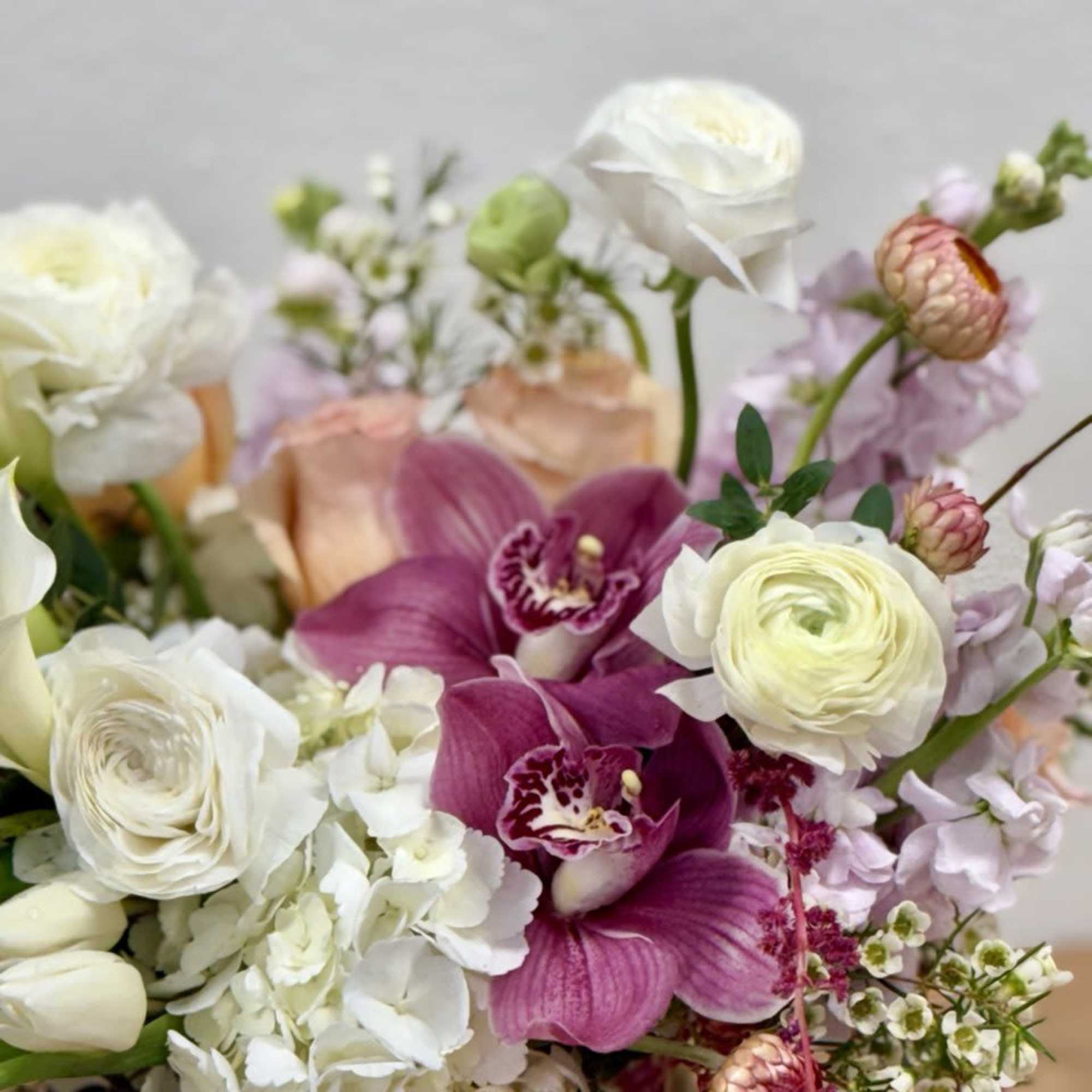 Bouquet of white and pink flowers with orchids and ranunculus
