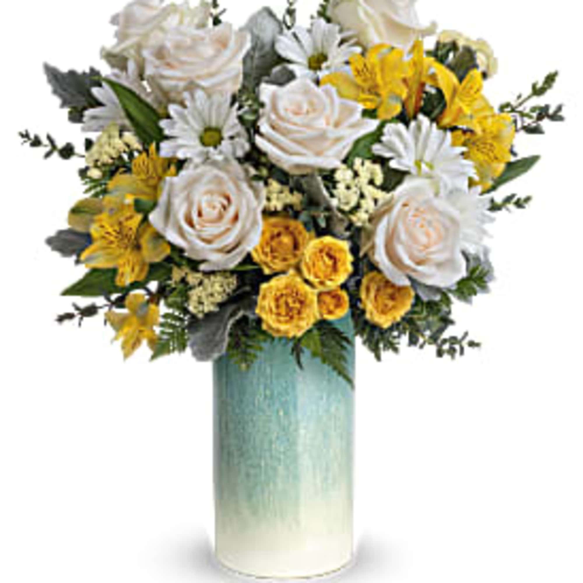 Tall arrangement of white roses, white daisies, and yellow blooms in a blue ombre cylinder vase