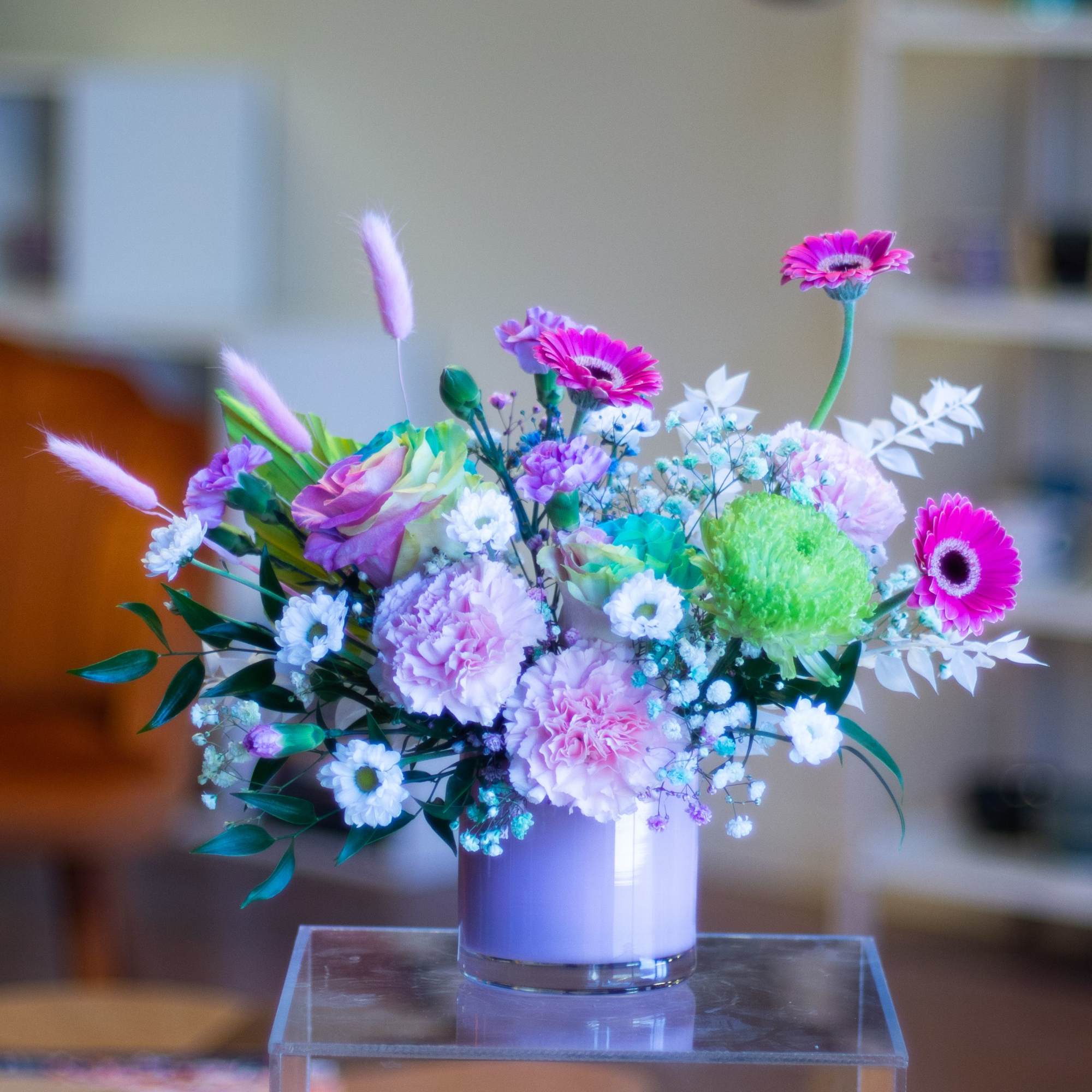Colorful bouquet in a clear glass vase with pink and white blooms