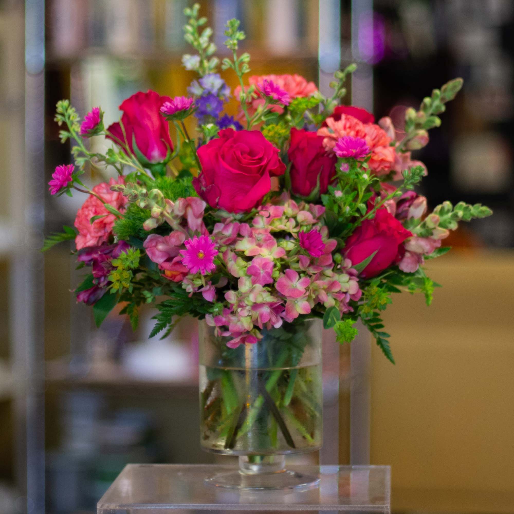 The design, flowers, and vessel used for this arrangement are left in