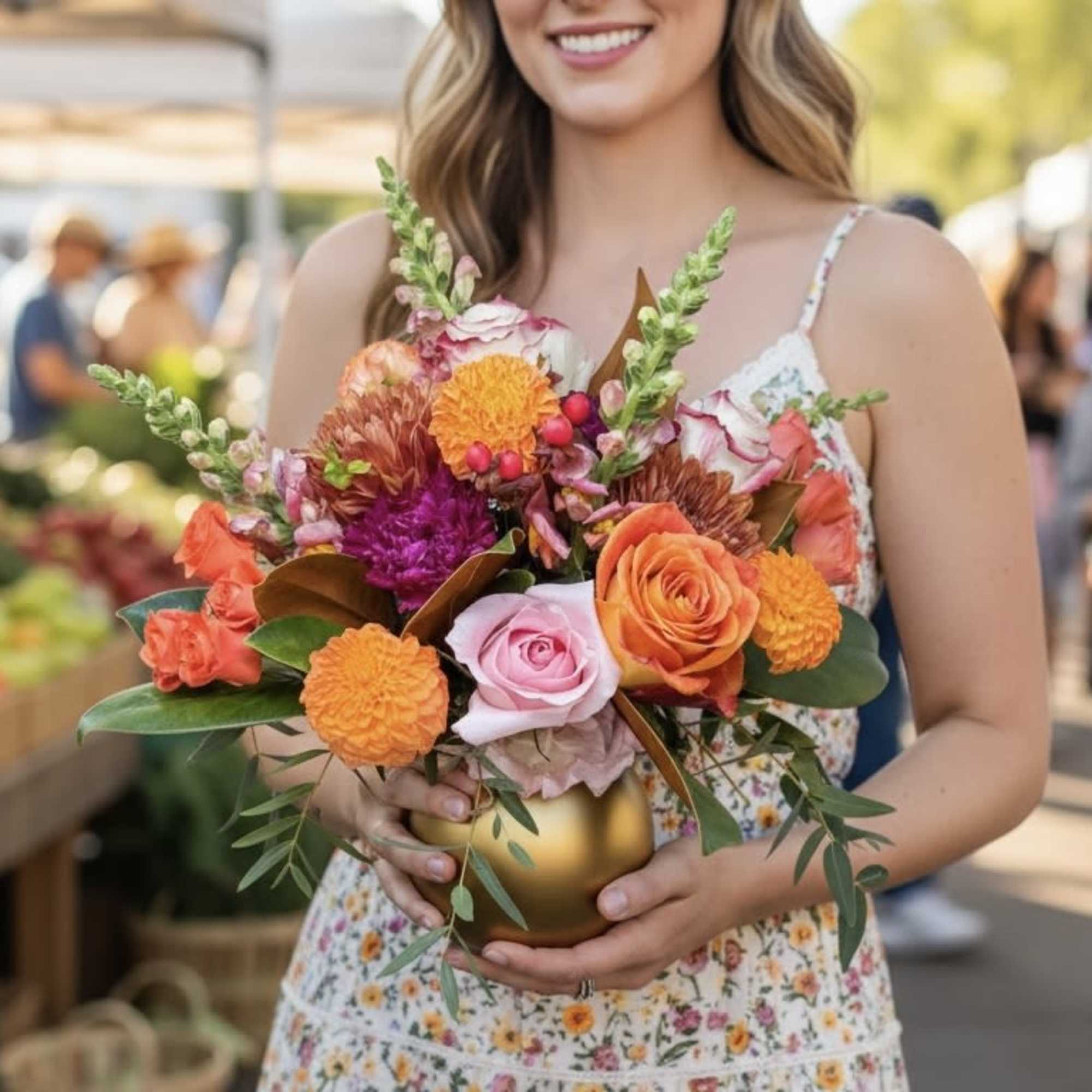 Woman holding a colorful bouquet in a gold vase