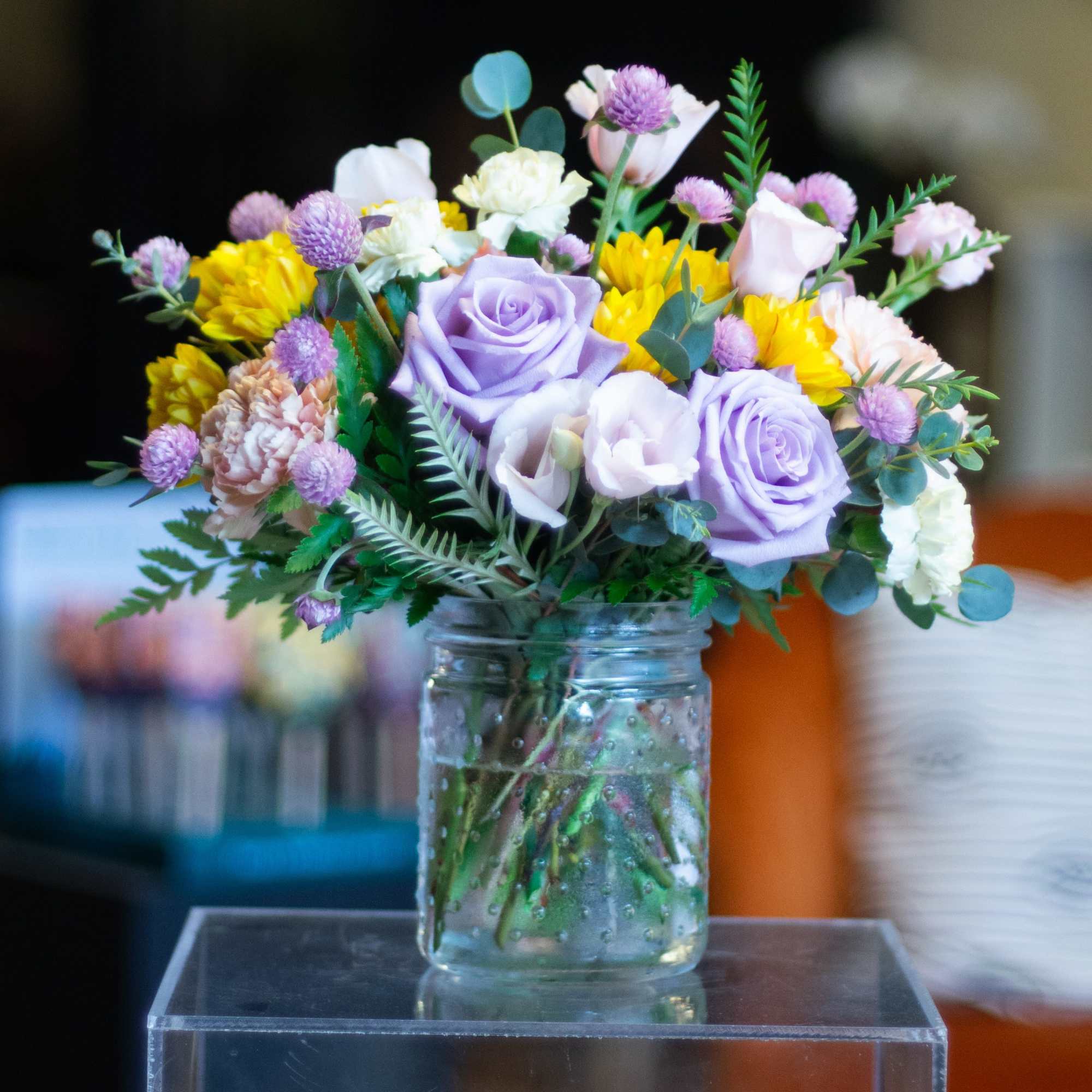 The design, flowers, and vessel used for this mini arrangement are left
