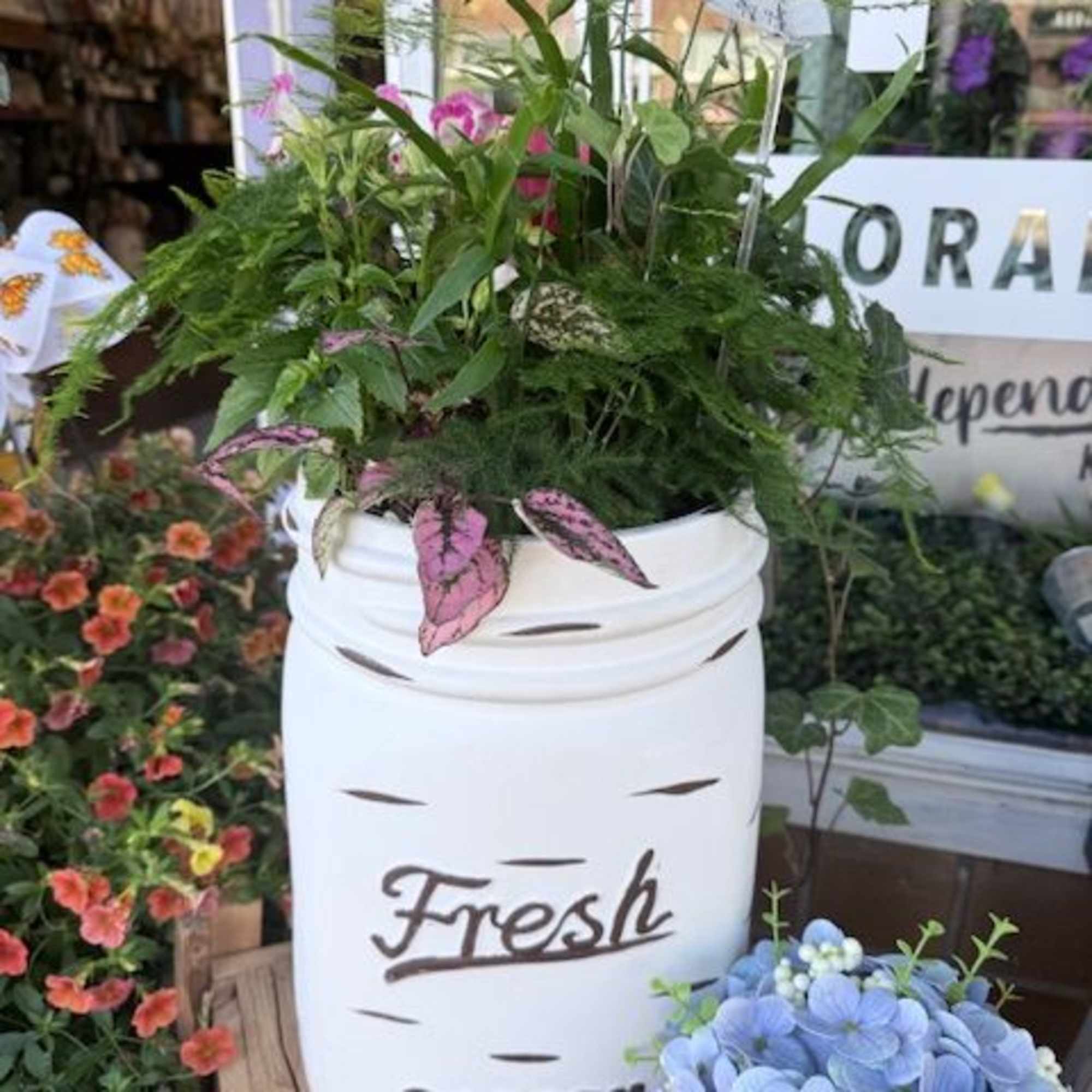 A cheerful, garden-fresh arrangement in a mason jar planter that feels like