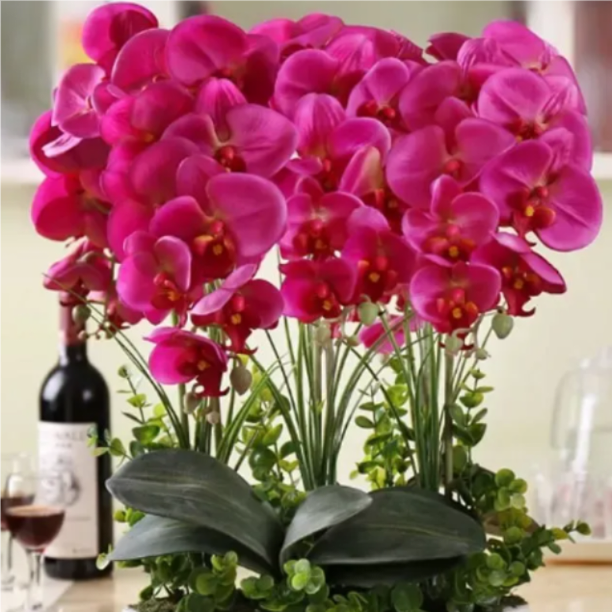 Bright pink orchid arrangement in a low container