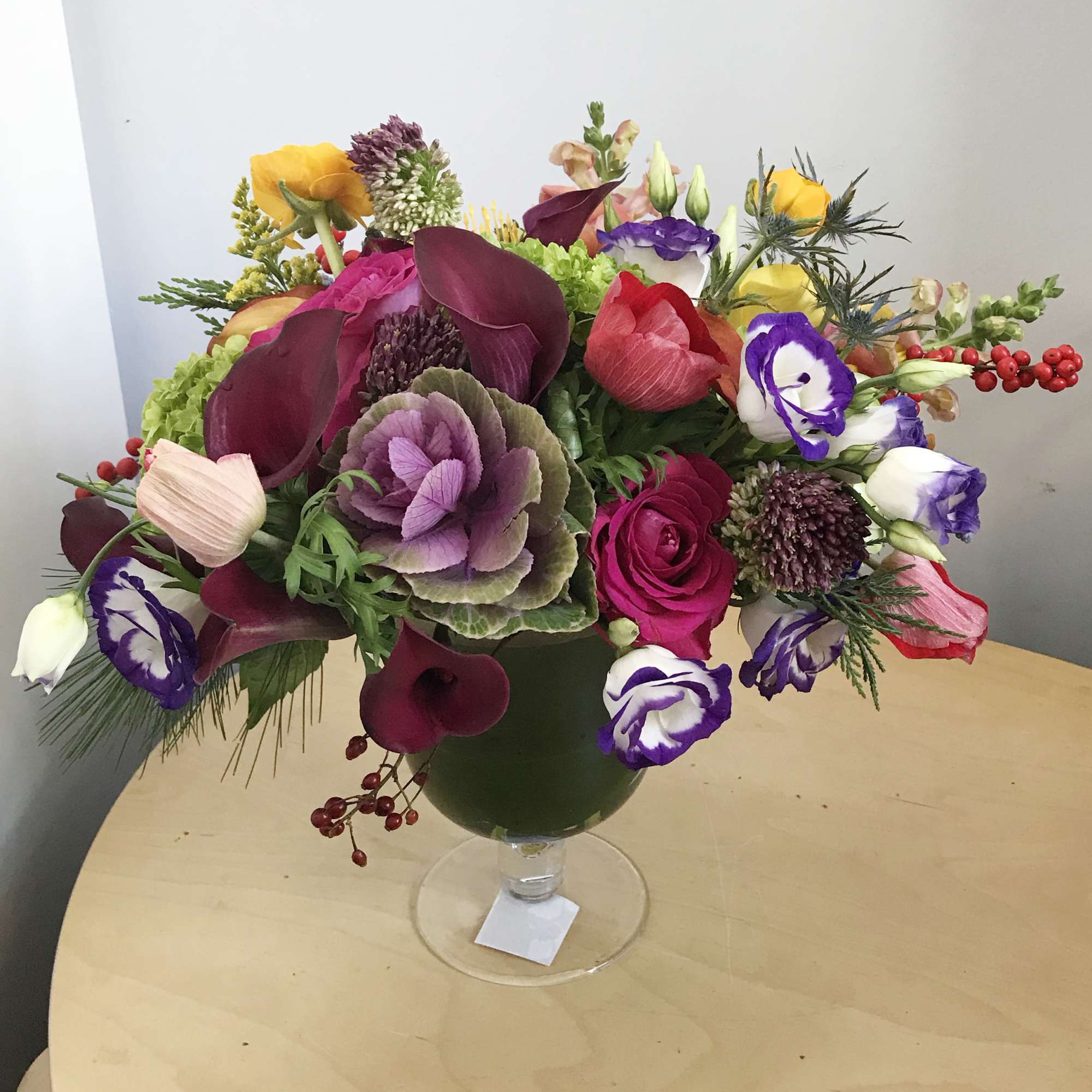 Mixed bouquet in a glass vase with purple, pink, yellow, and white blooms