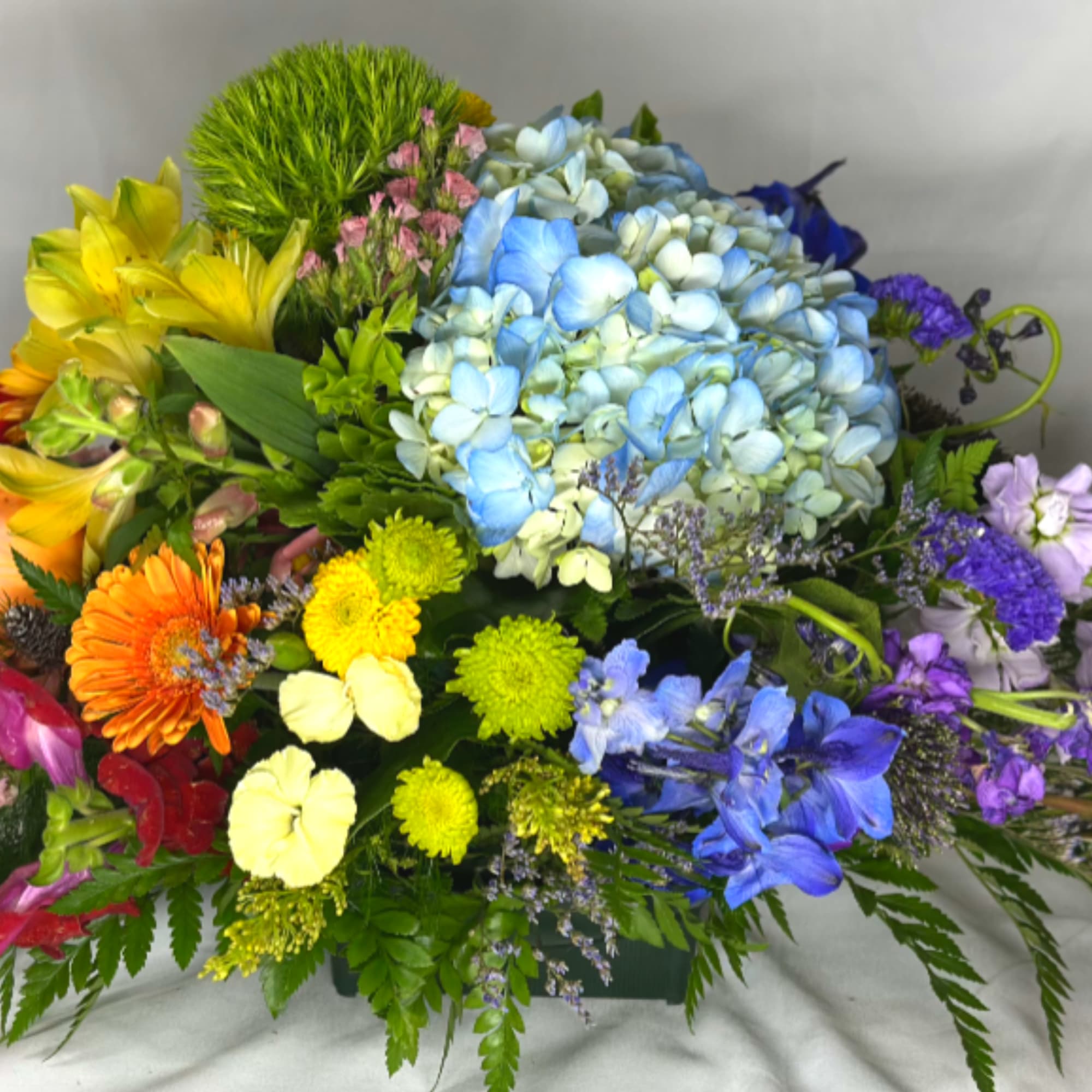 We love chasing rainbows. This Leary's flowers exclusive design features red, orange