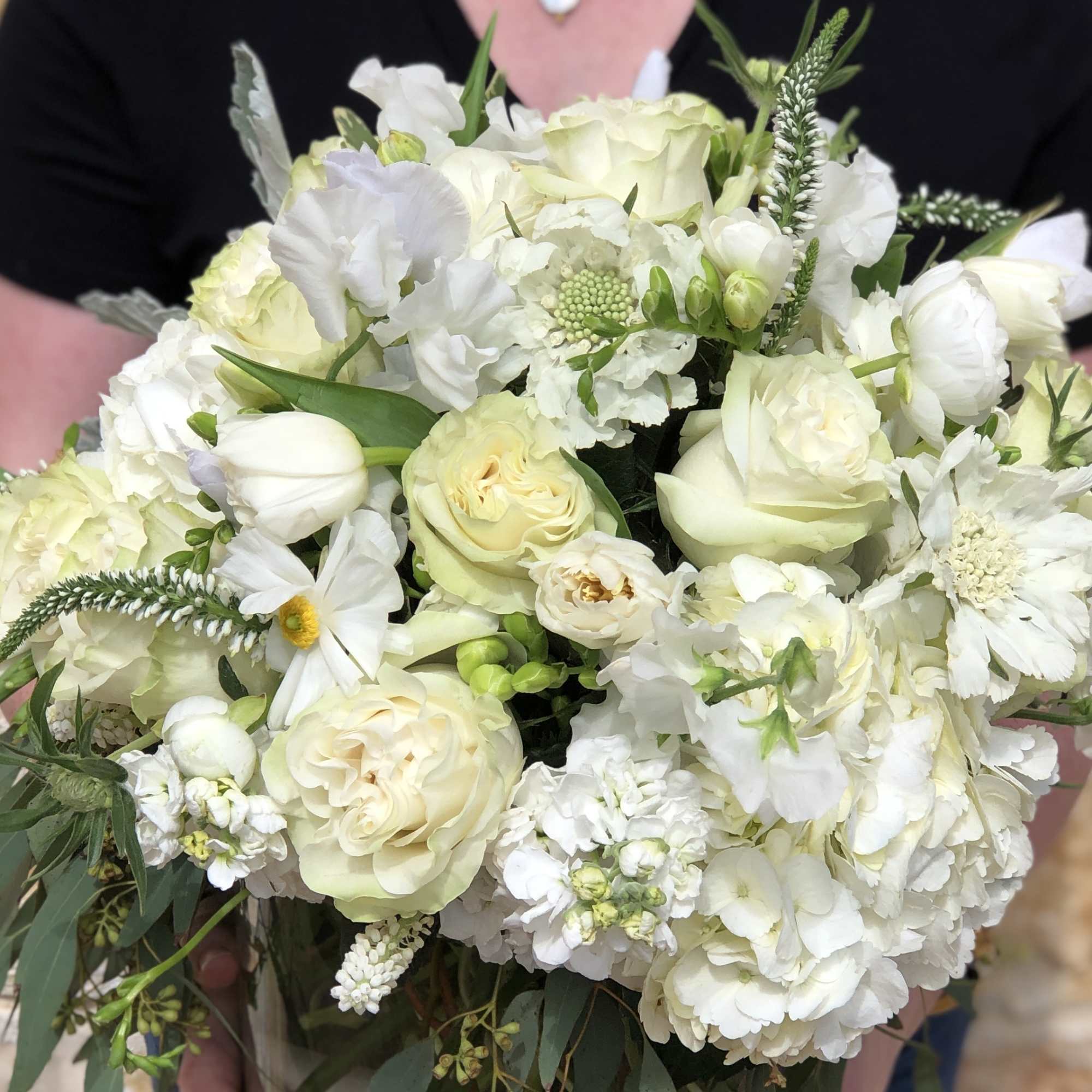 White bouquet of roses, tulips, and daisies