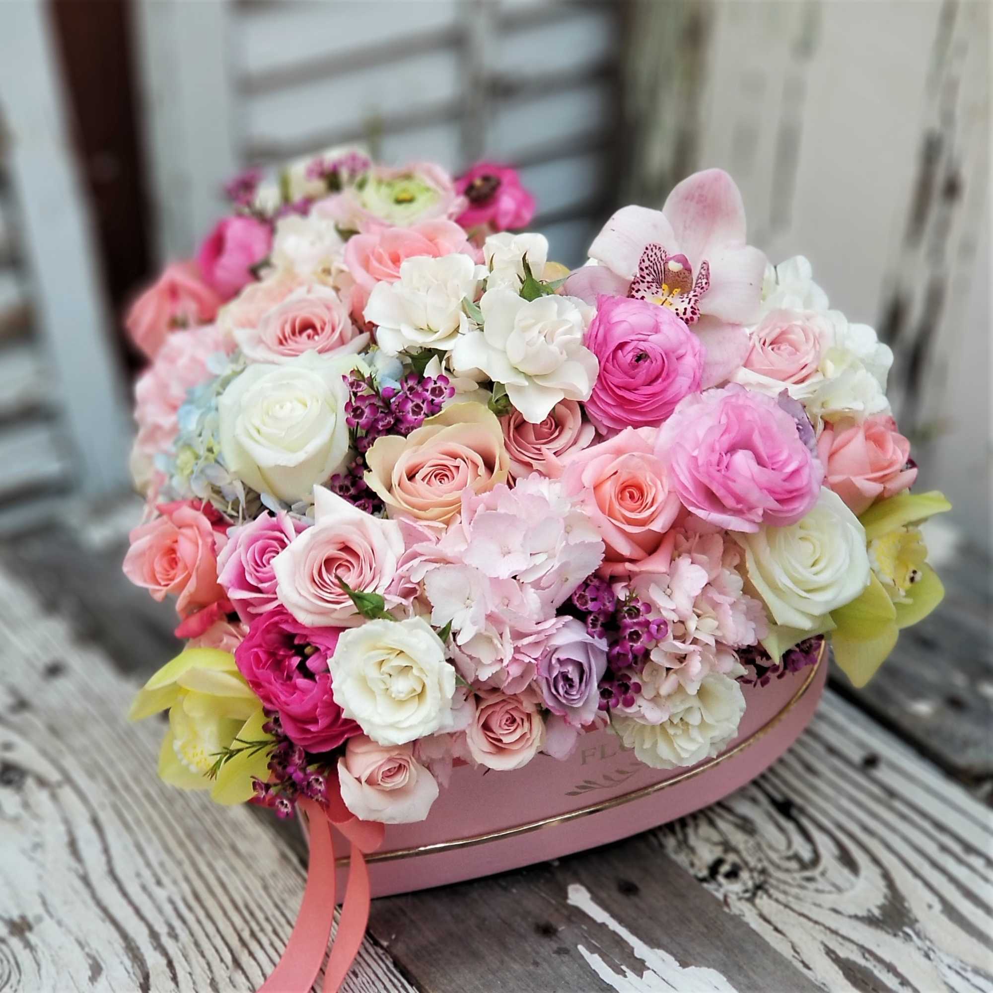 Pink and white rose bouquet in a heart-shaped box