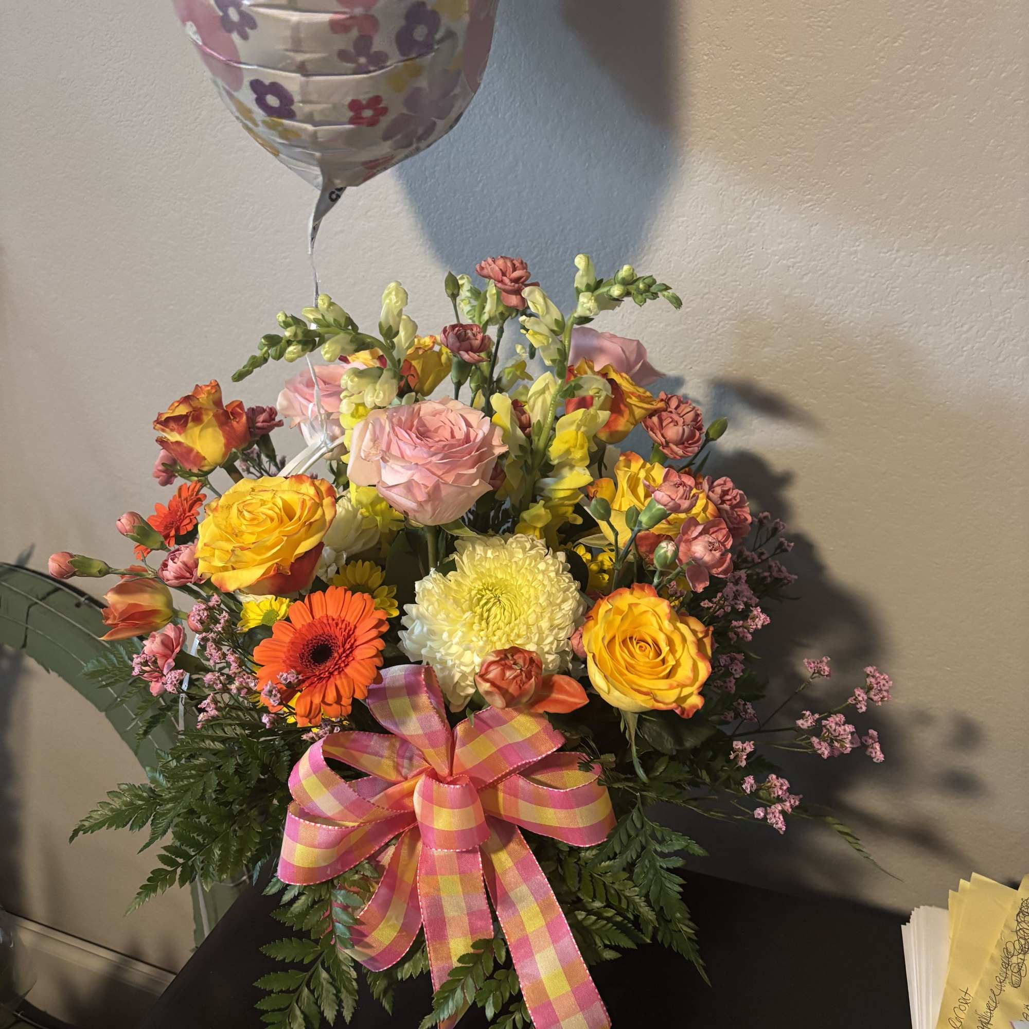 Beautuful basket of mixed roses, tulips, mums, daisys etc. with a pretty