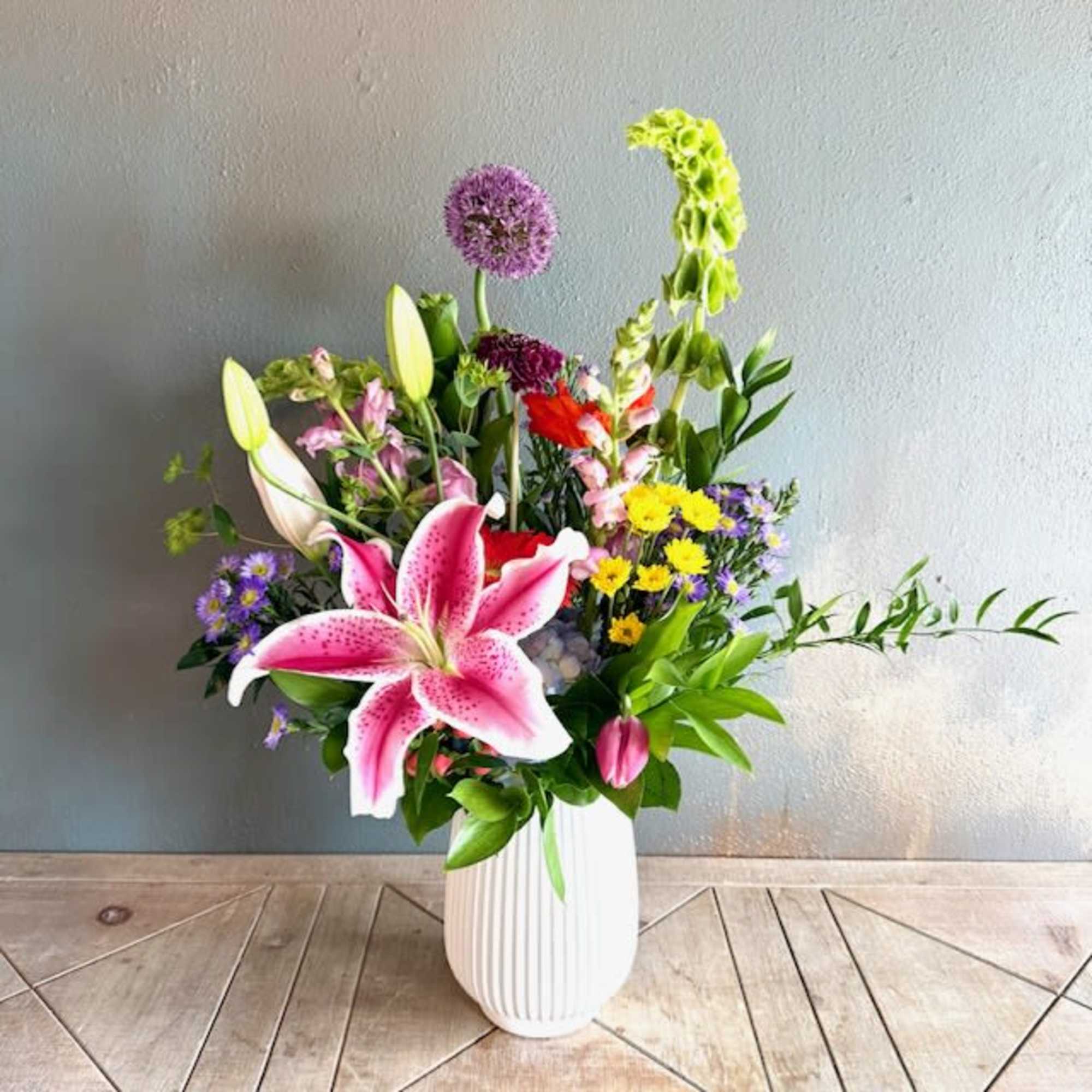 A big beautiful lily (variety will vary) greets the eye in this