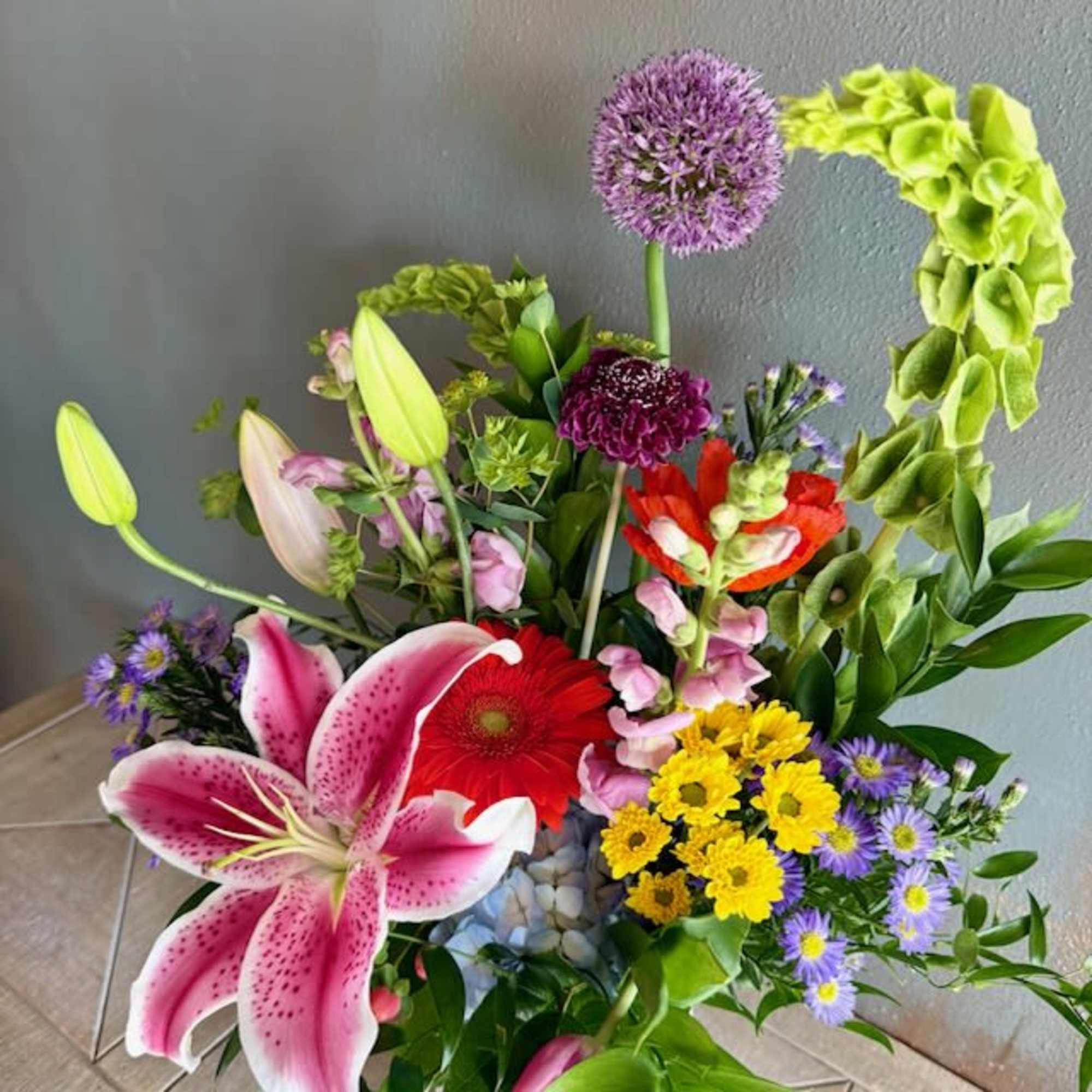 A big beautiful lily (variety will vary) greets the eye in this