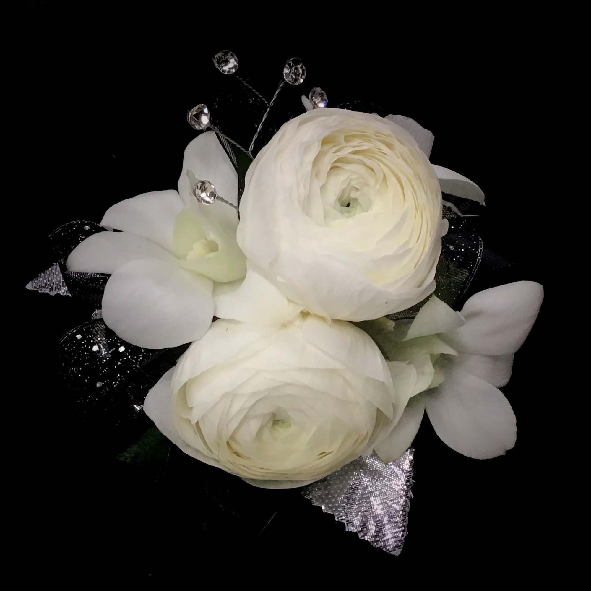 White ranunculus bouquet with crystal accents on a black background