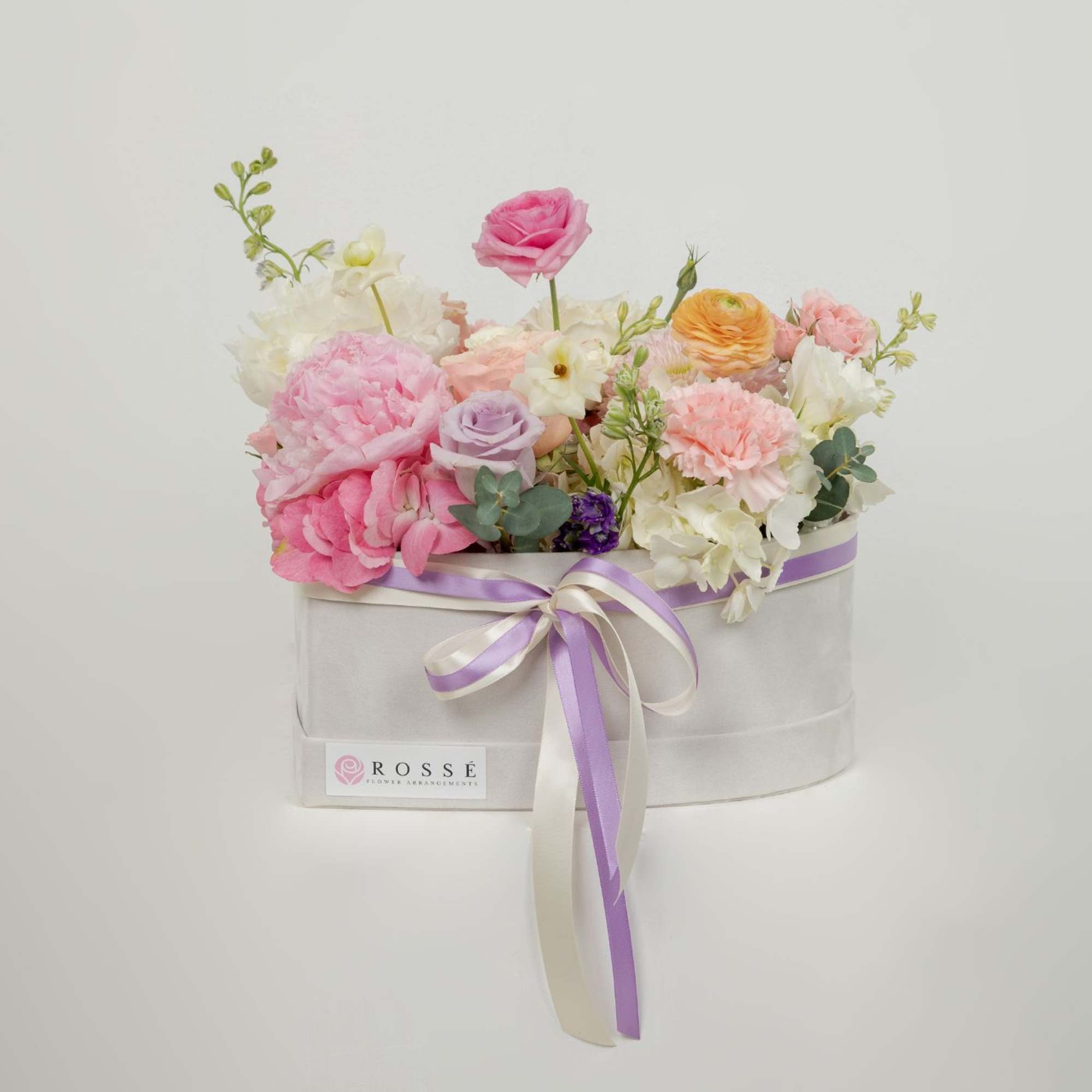 A garden-style mix flower arrangement in a velvet heart box.
Soft pastel blooms