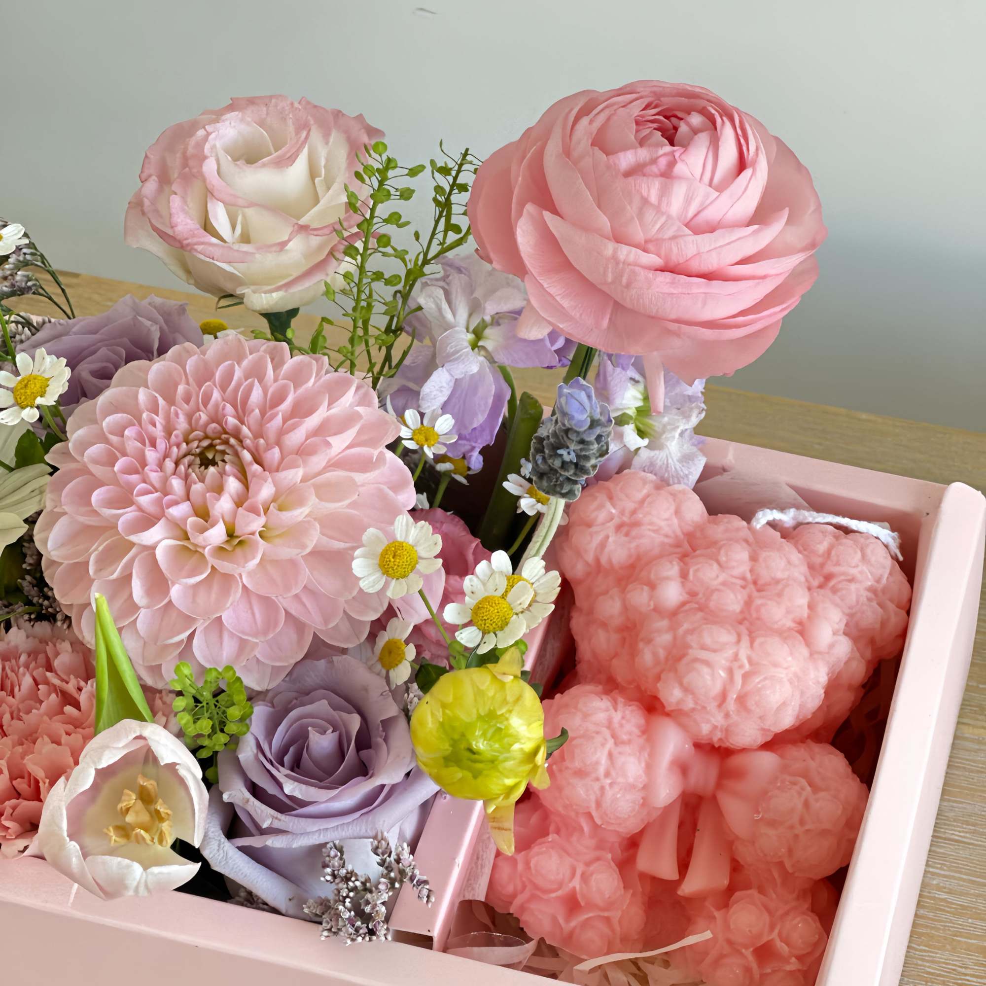Pink and lavender floral arrangement in a pink box with a heart-shaped plush