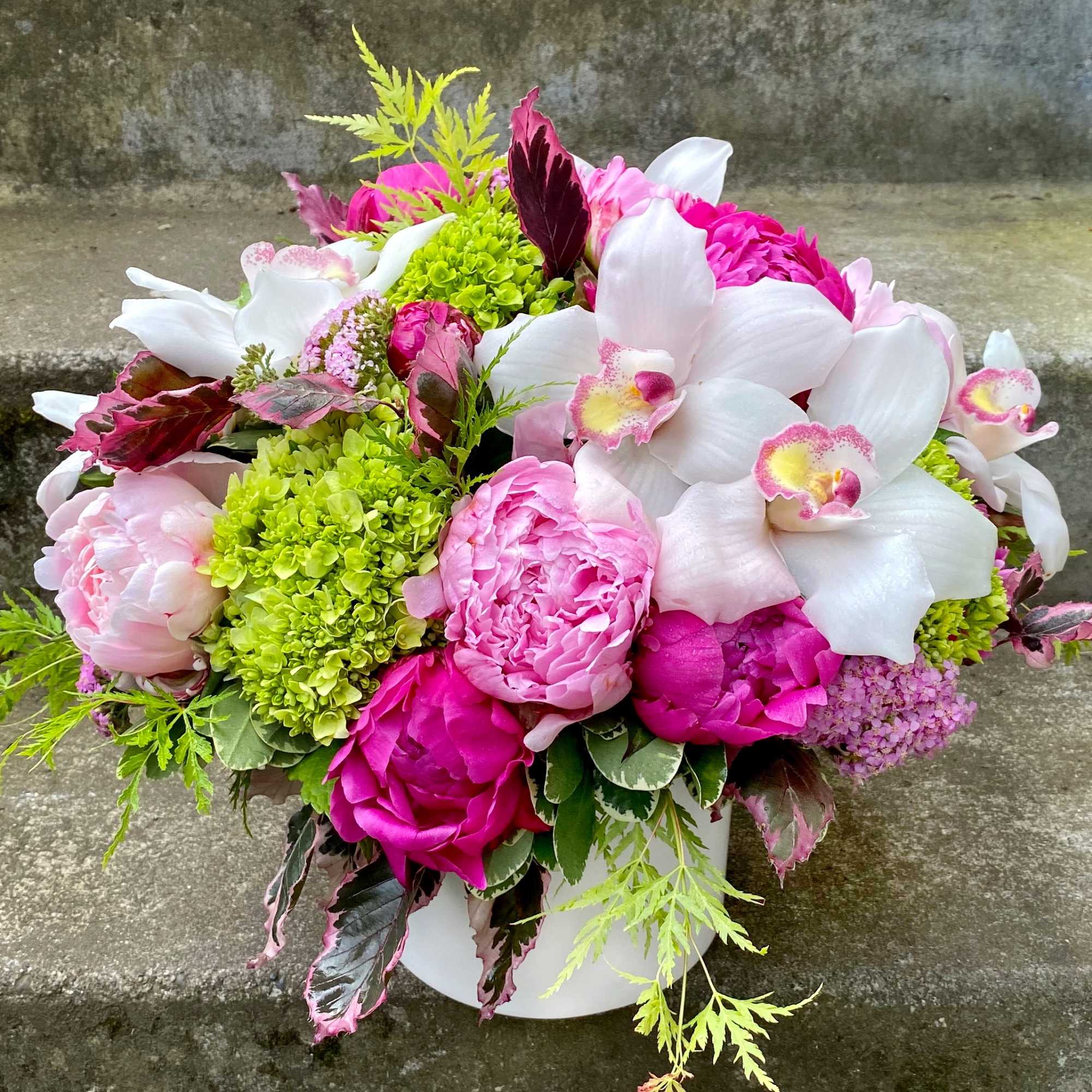 Pink and white floral arrangement in a white vase