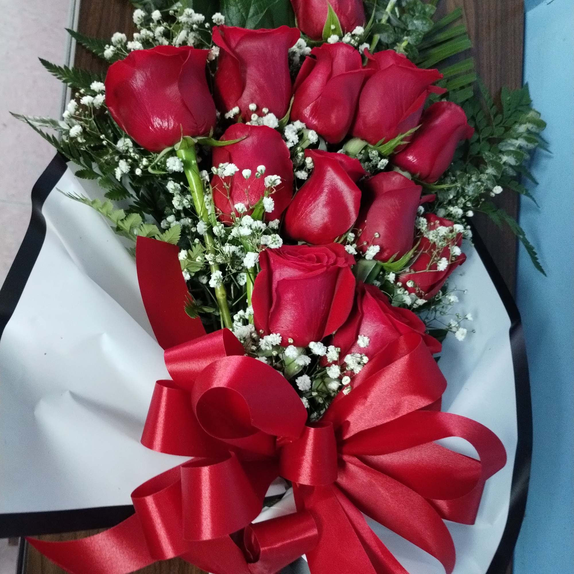 Bouquet of red roses with baby's breath and a red ribbon