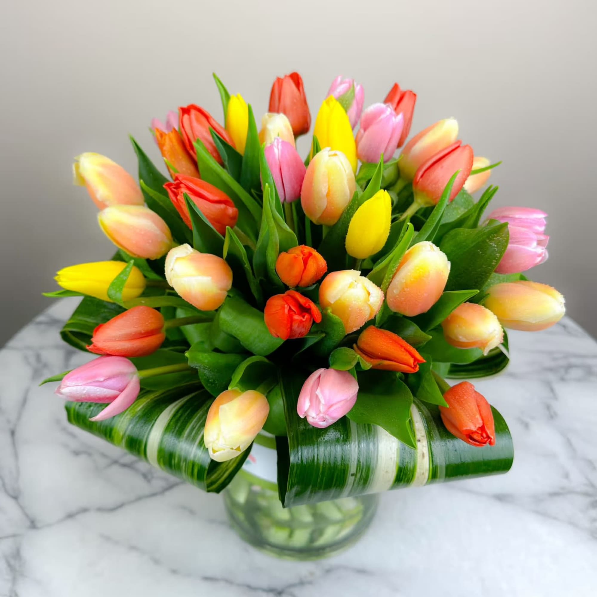 45 colorful tulips elegantly arranged in a keepsake mason jar vase. 

Approximately