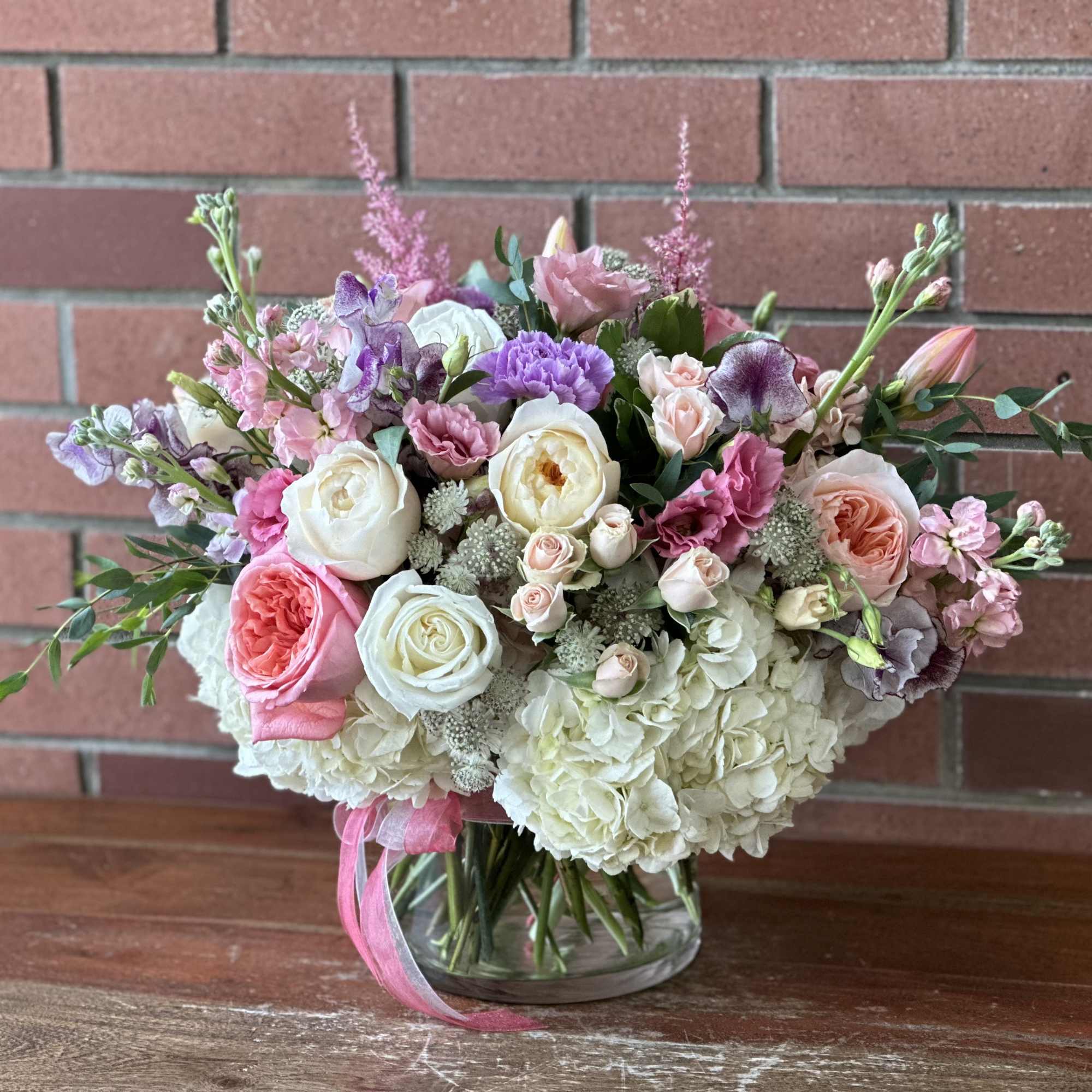 Mixed pink and white bouquet in a clear glass vase