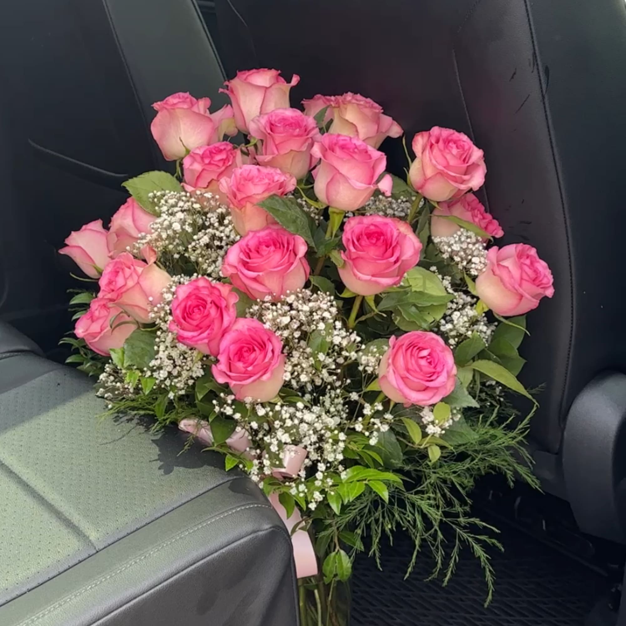 Bouquet of pink roses with baby's breath and greenery
