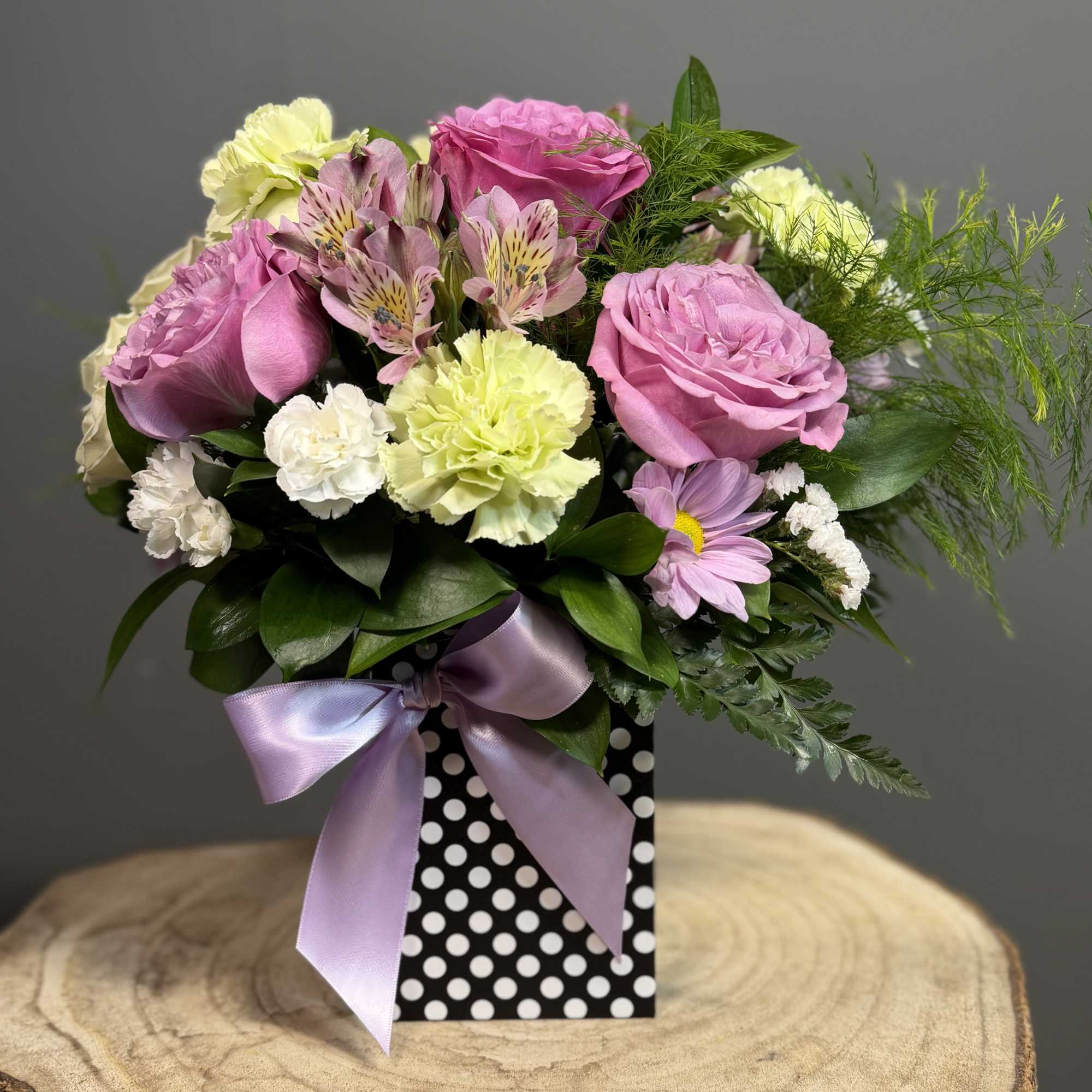 A graceful blend of roses, alstroemeria, and carnations in gentle hues, accented