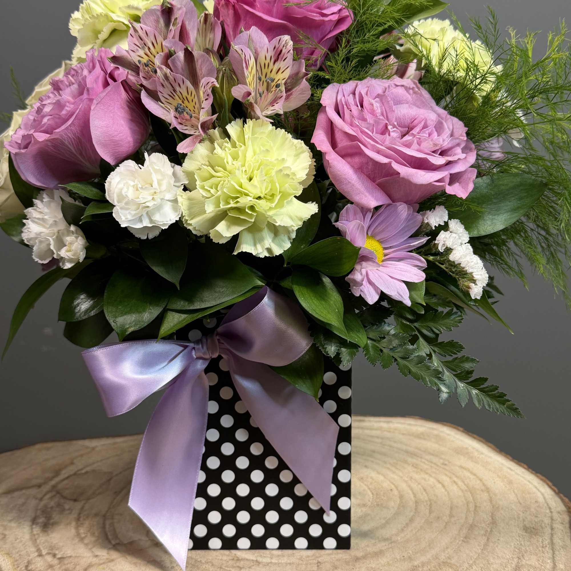 A graceful blend of roses, alstroemeria, and carnations in gentle hues, accented