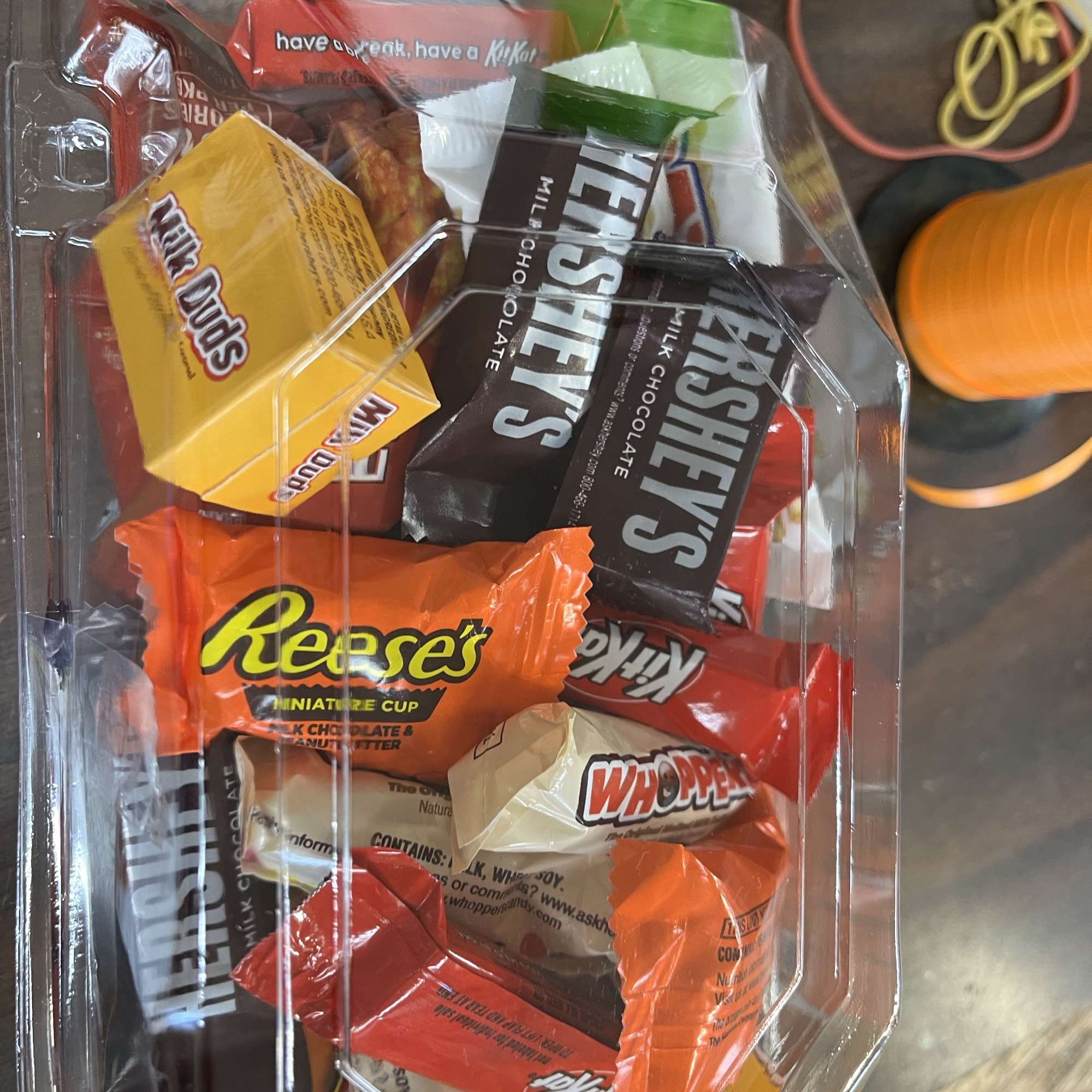 Plastic tray filled with assorted wrapped chocolates and candy bars