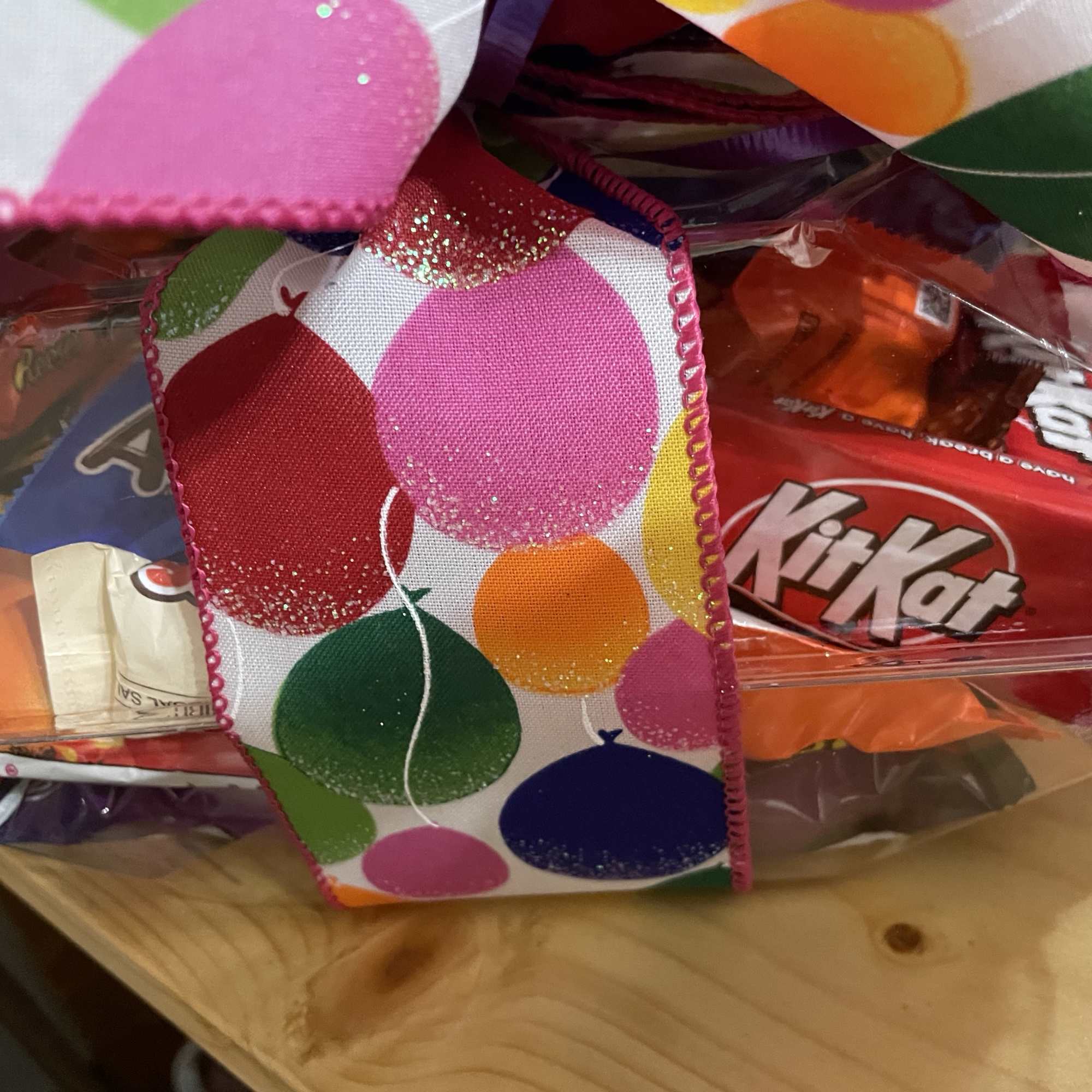 Gift basket with assorted candy bars and a colorful polka-dot ribbon