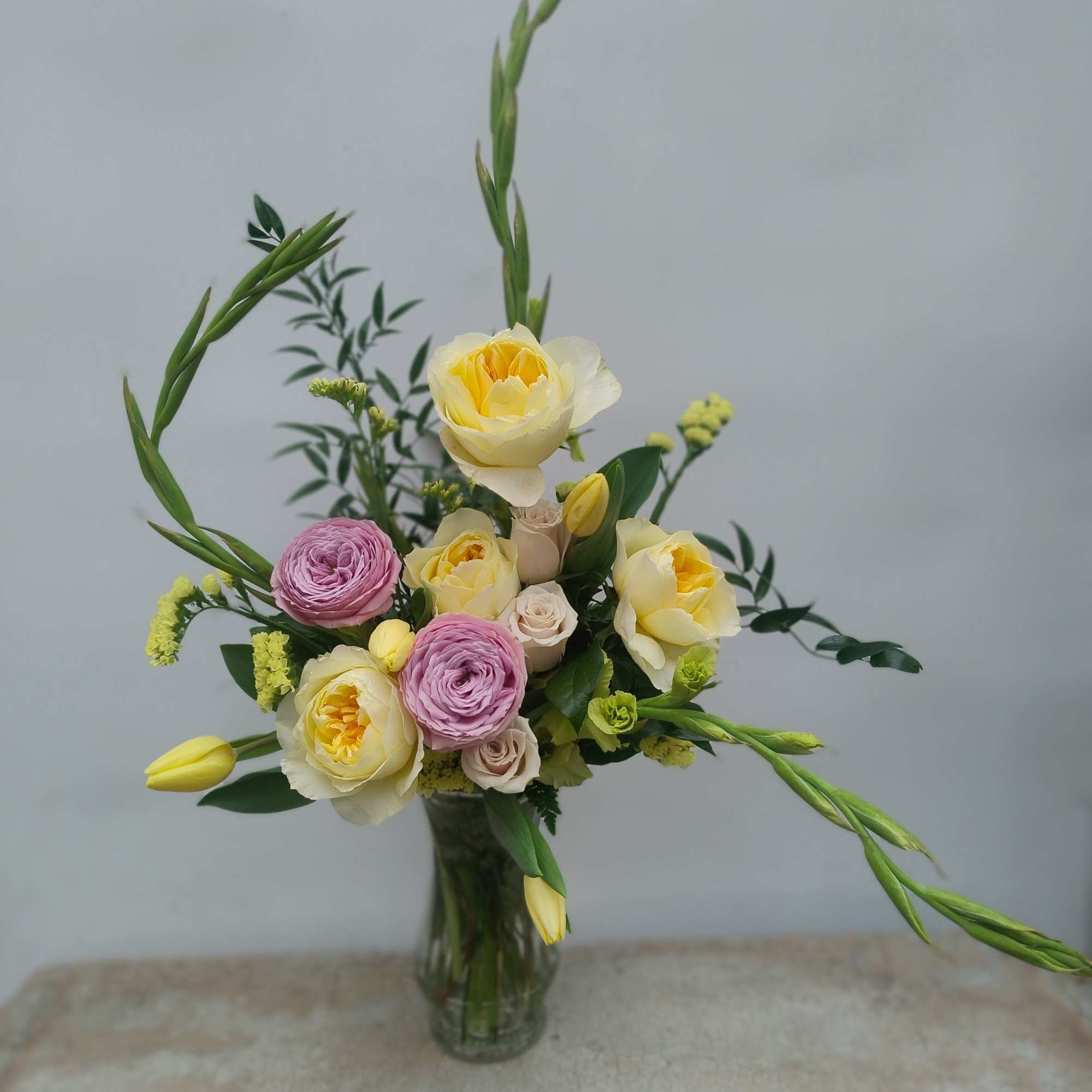 Soft spring pastels featuring garden roses &amp; tulips.