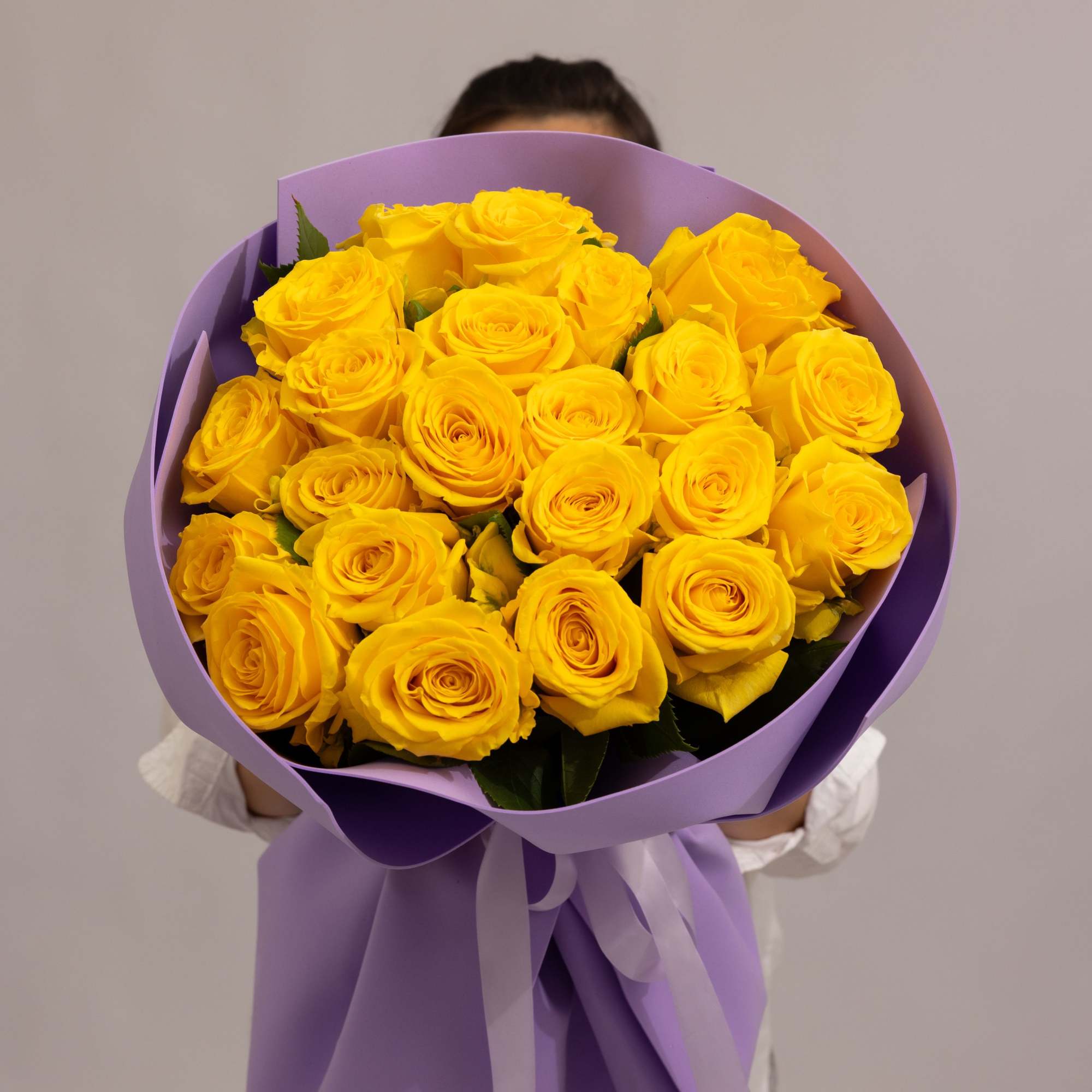 A radiant bouquet of 24  roses in a rich yellow tone.
