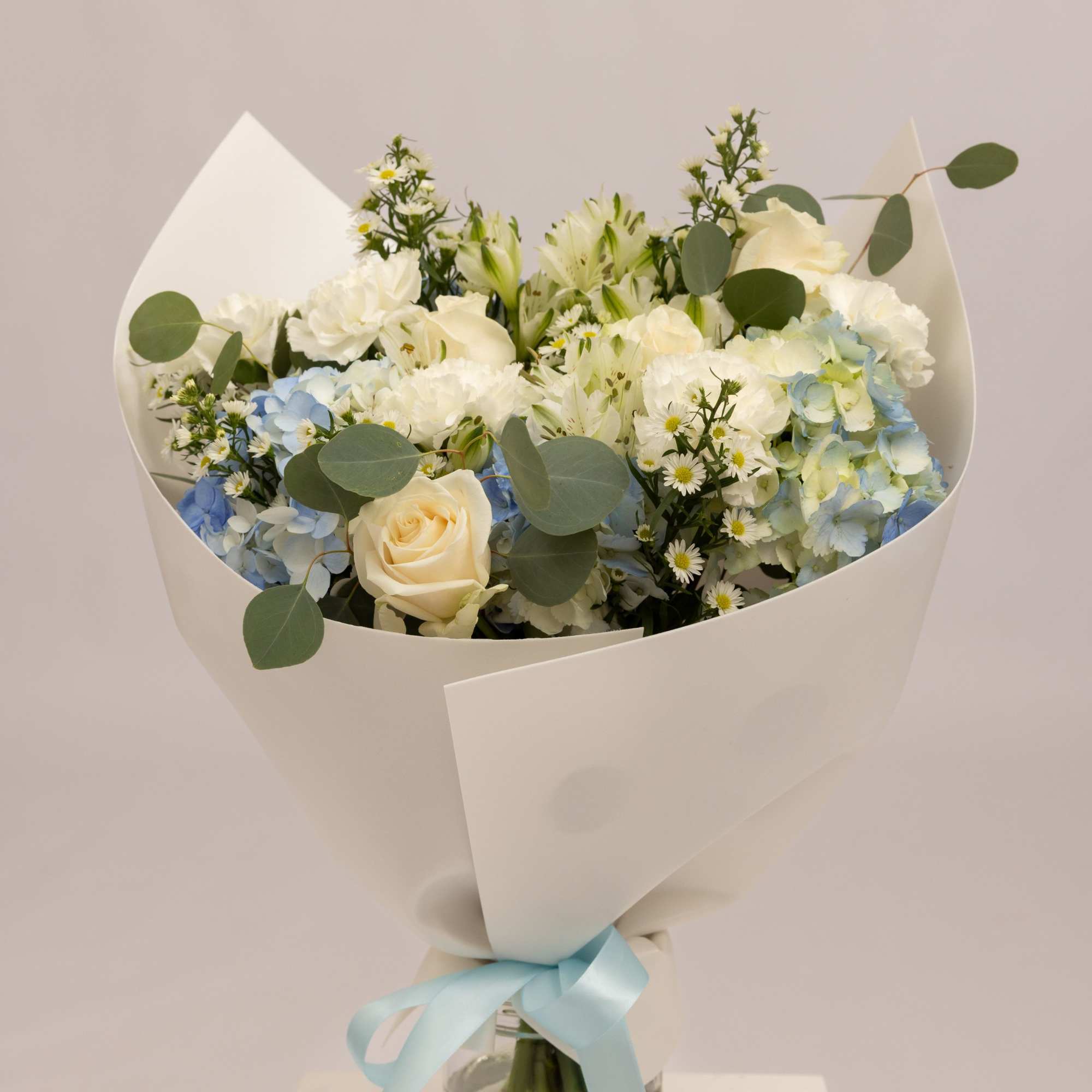 A delicate and airy bouquet in soft blue and white tones, featuring