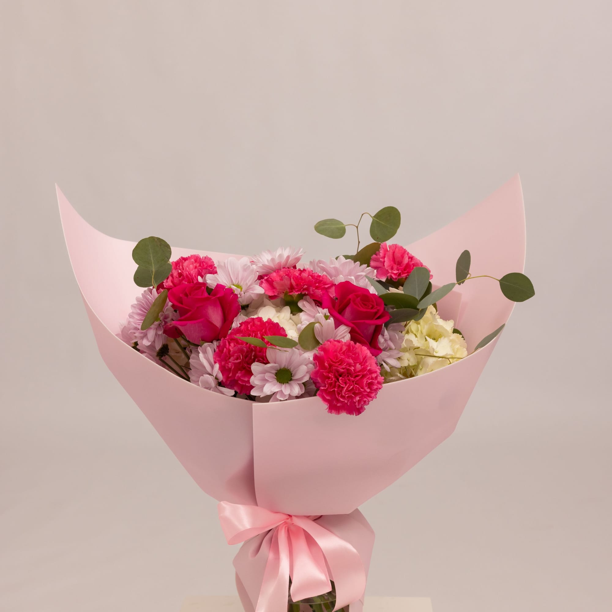 A vibrant and playful bouquet in rich pink tones, featuring pink or
