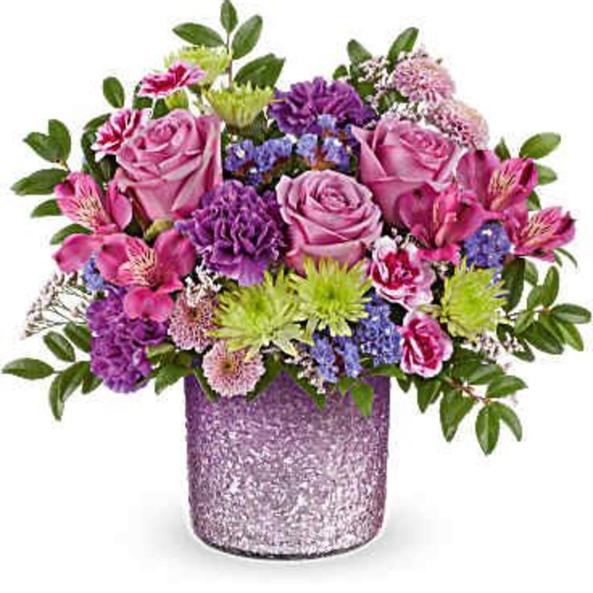 Pink and purple mixed flower arrangement in a glittery vase