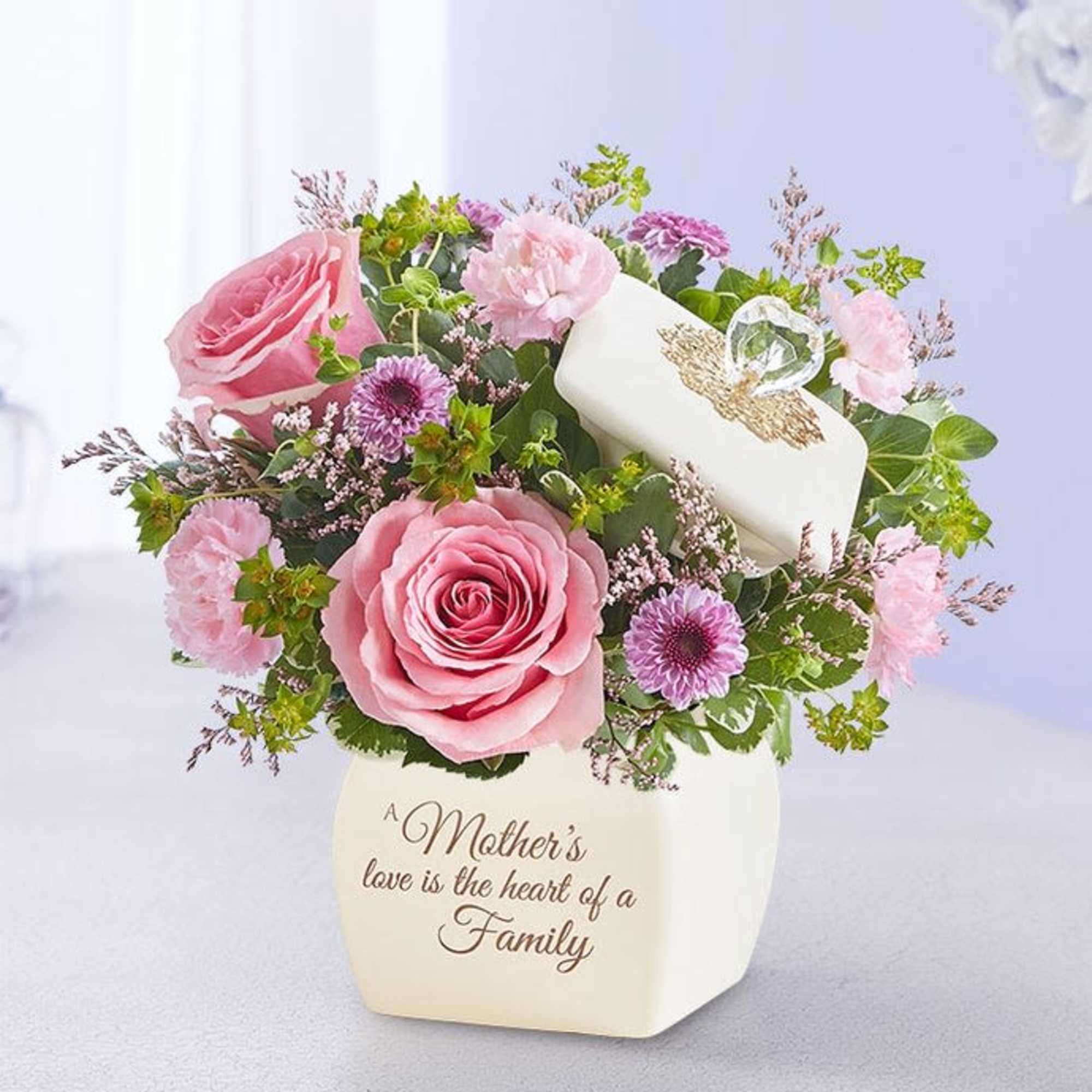 Pink roses and purple flowers in a white vase with a Mother's Day message