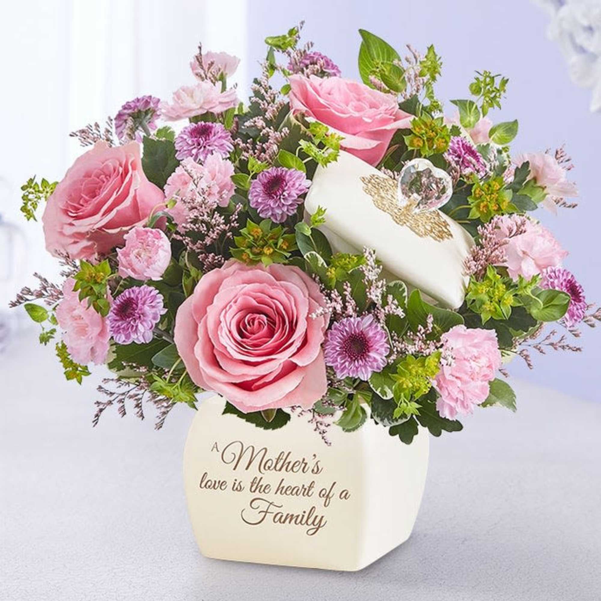 Pink roses and purple flowers in a white vase with a Mother’s Day message
