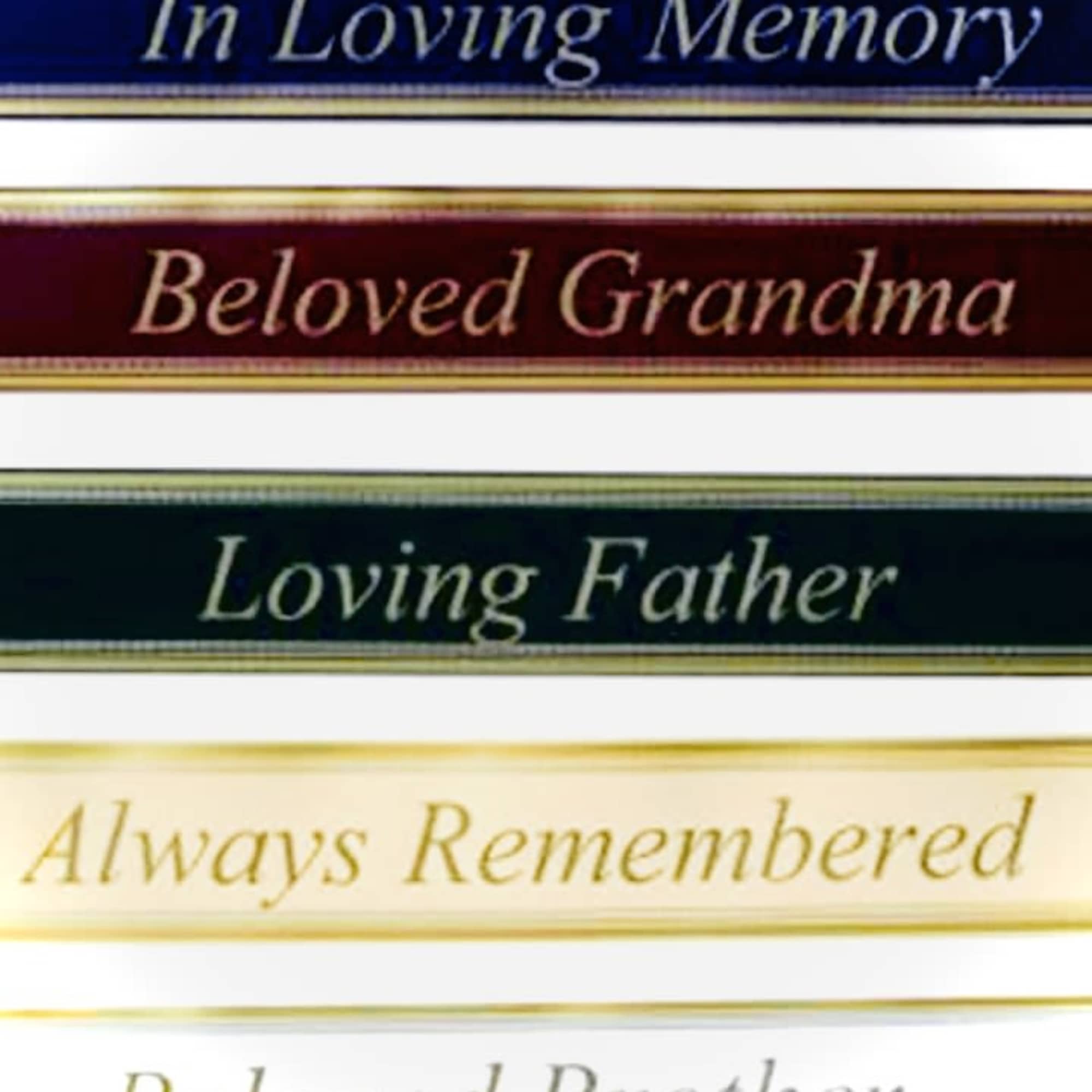 Stacked memorial ribbon tags take center stage in this sympathy arrangement, offering