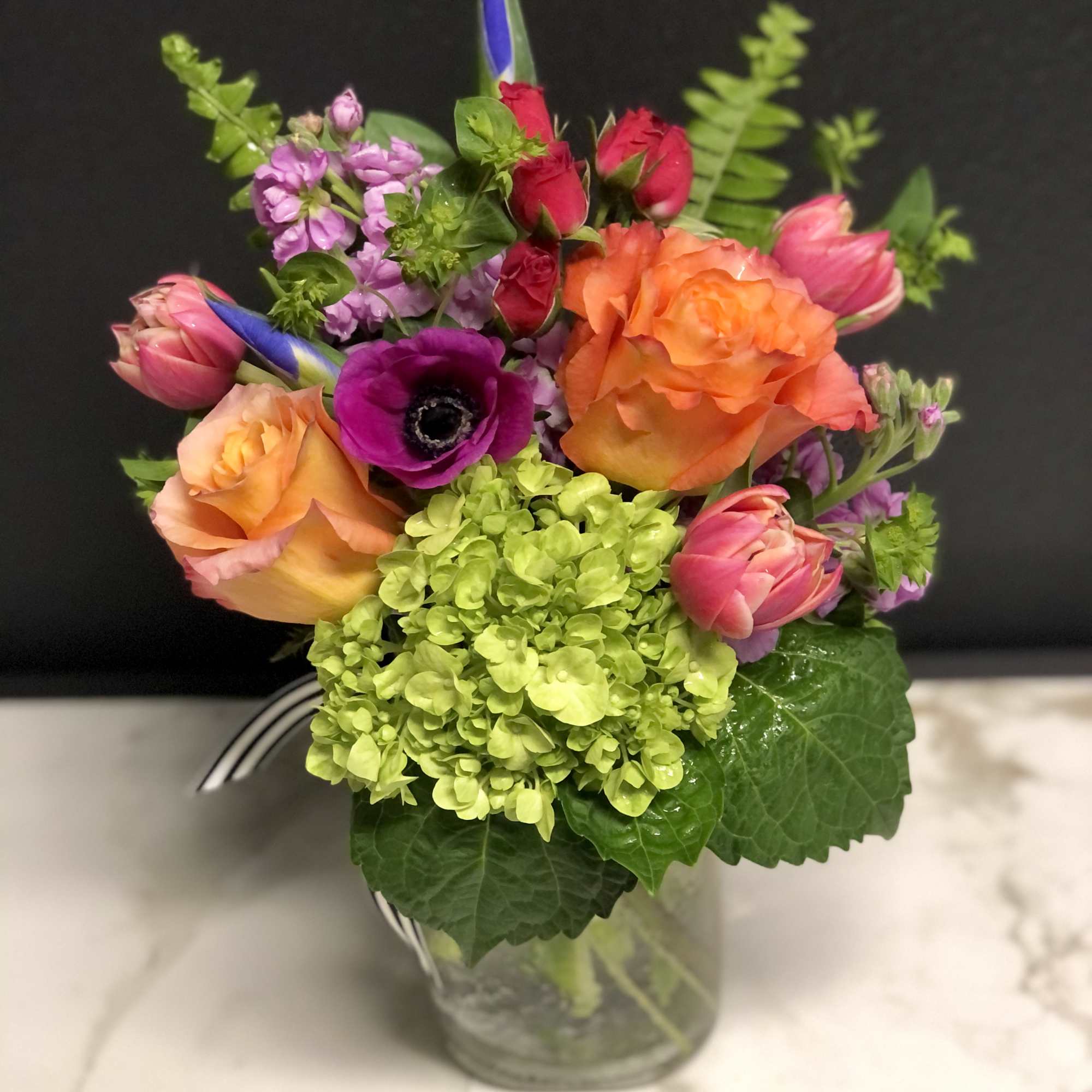 A bright, colorful, garden mix with season's prettiest blossoms. Arranged in our