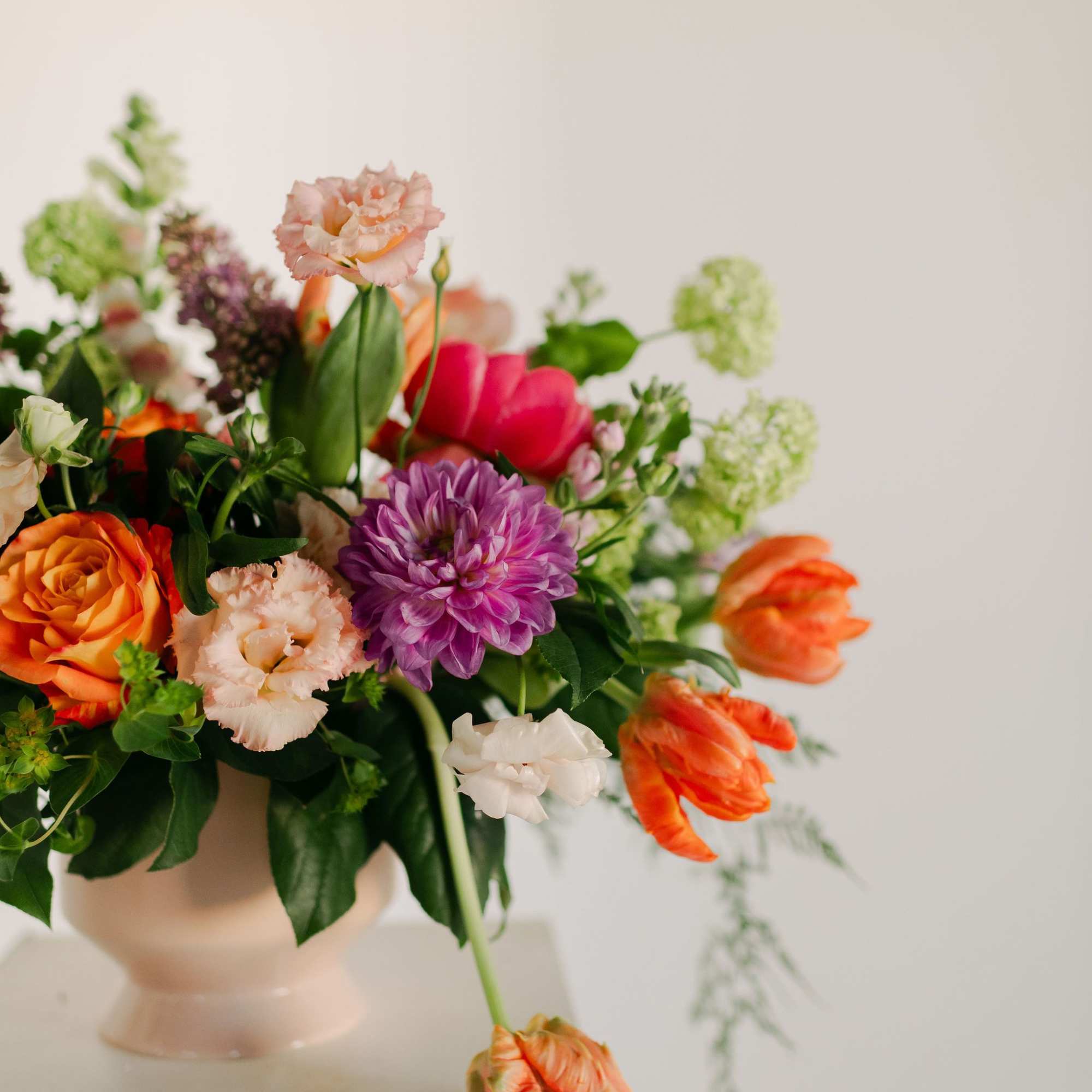 A lush blend of peaches, blush pinks, soft lavenders, and fresh greens
