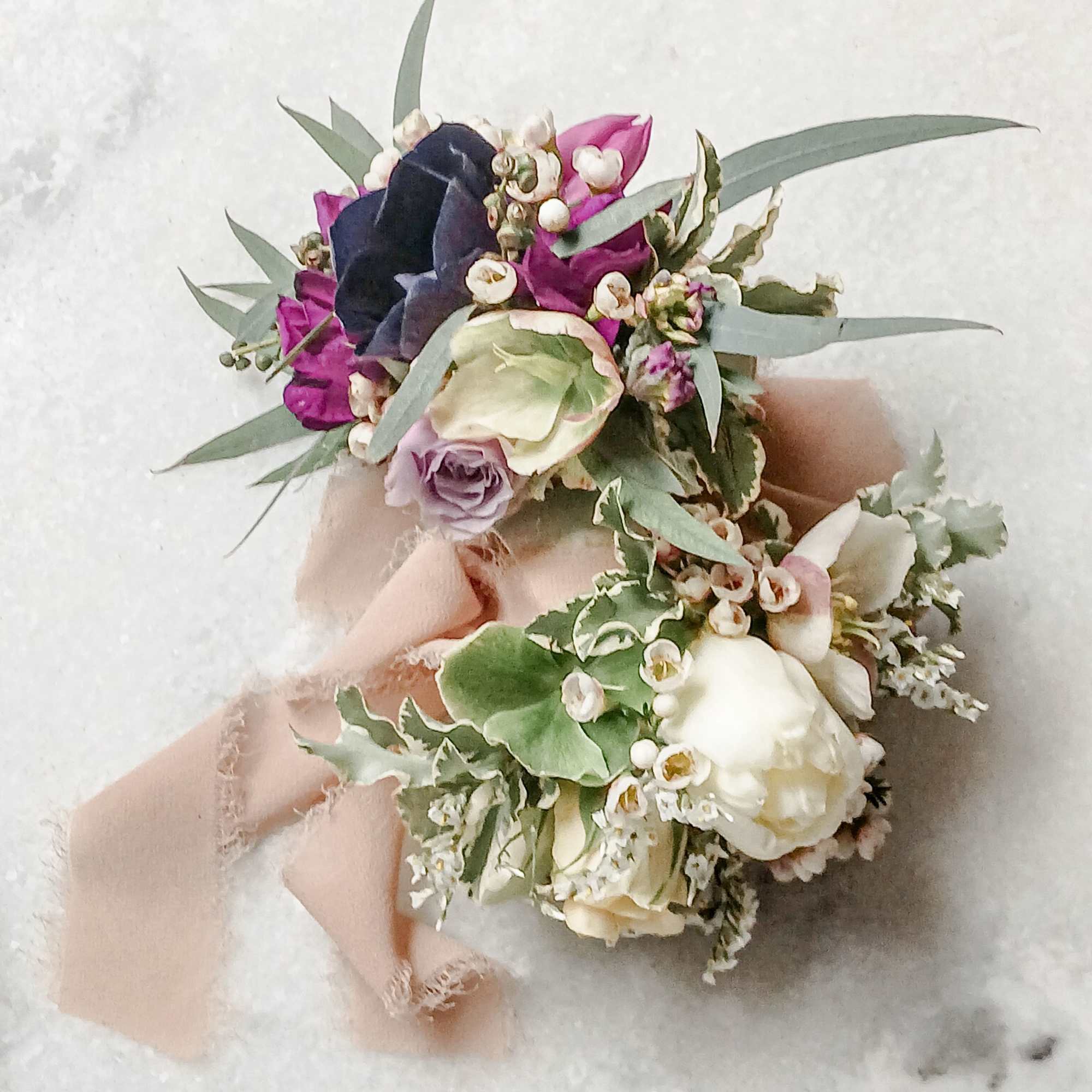 Two small floral bouquets with pink, white, and purple blooms