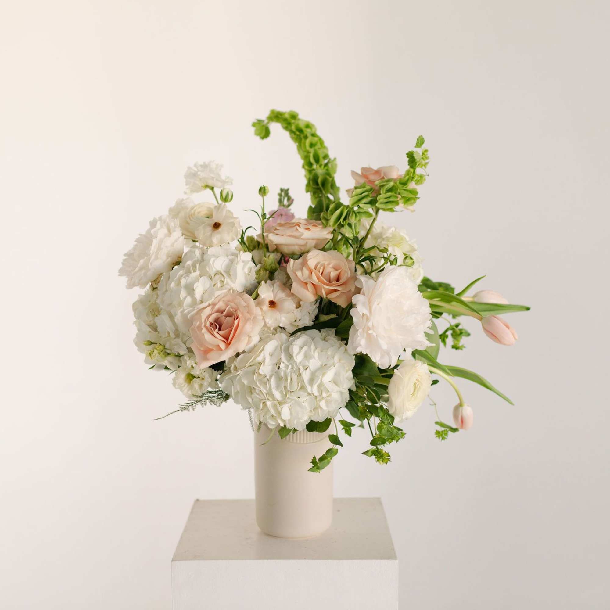 A sweet, pretty arrangement with a sassy edge, this modern twist on